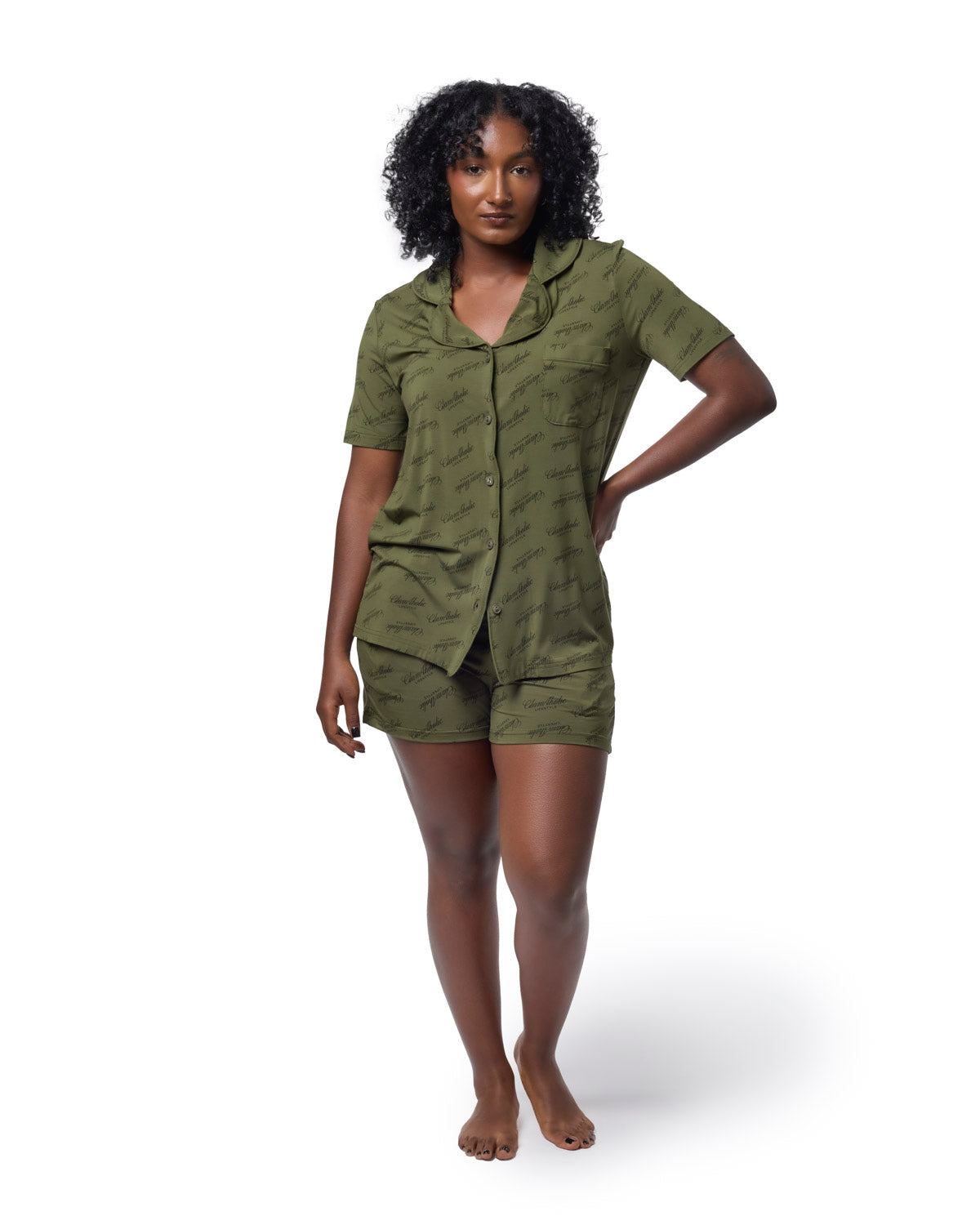 Model wearing a green pajama short set featuring a stylish print, perfect for comfortable and chic lounging.