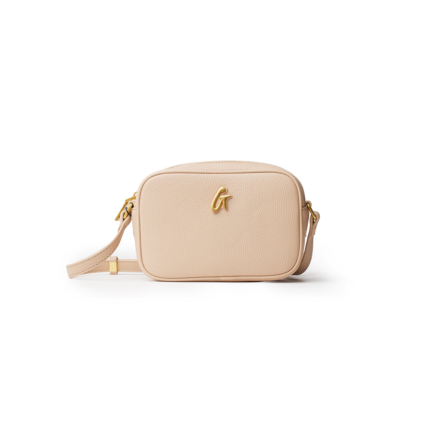 Mini pebble camera bag in nude color with gold hardware and a detachable strap, designed for stylish carrying of essentials.