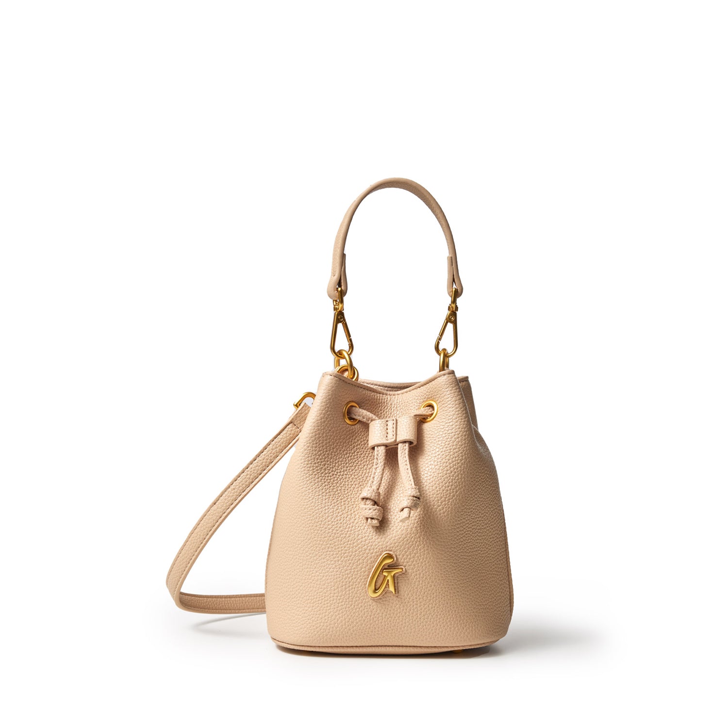 Mini pebble bucket bag in nude color with gold hardware, drawstring closure, and adjustable strap.