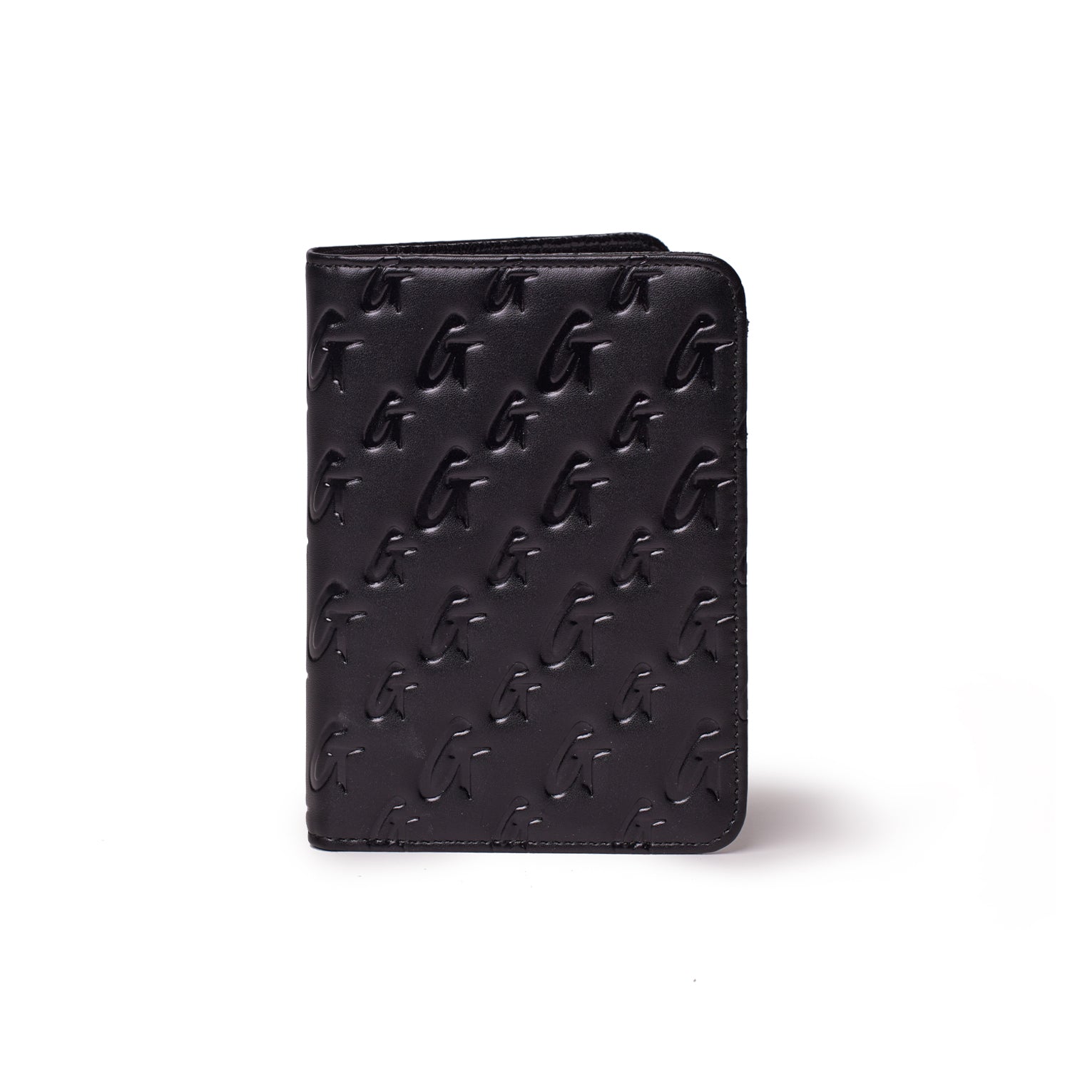 Black monogram passport holder with embossed G pattern, compact and stylish for travel accessories.