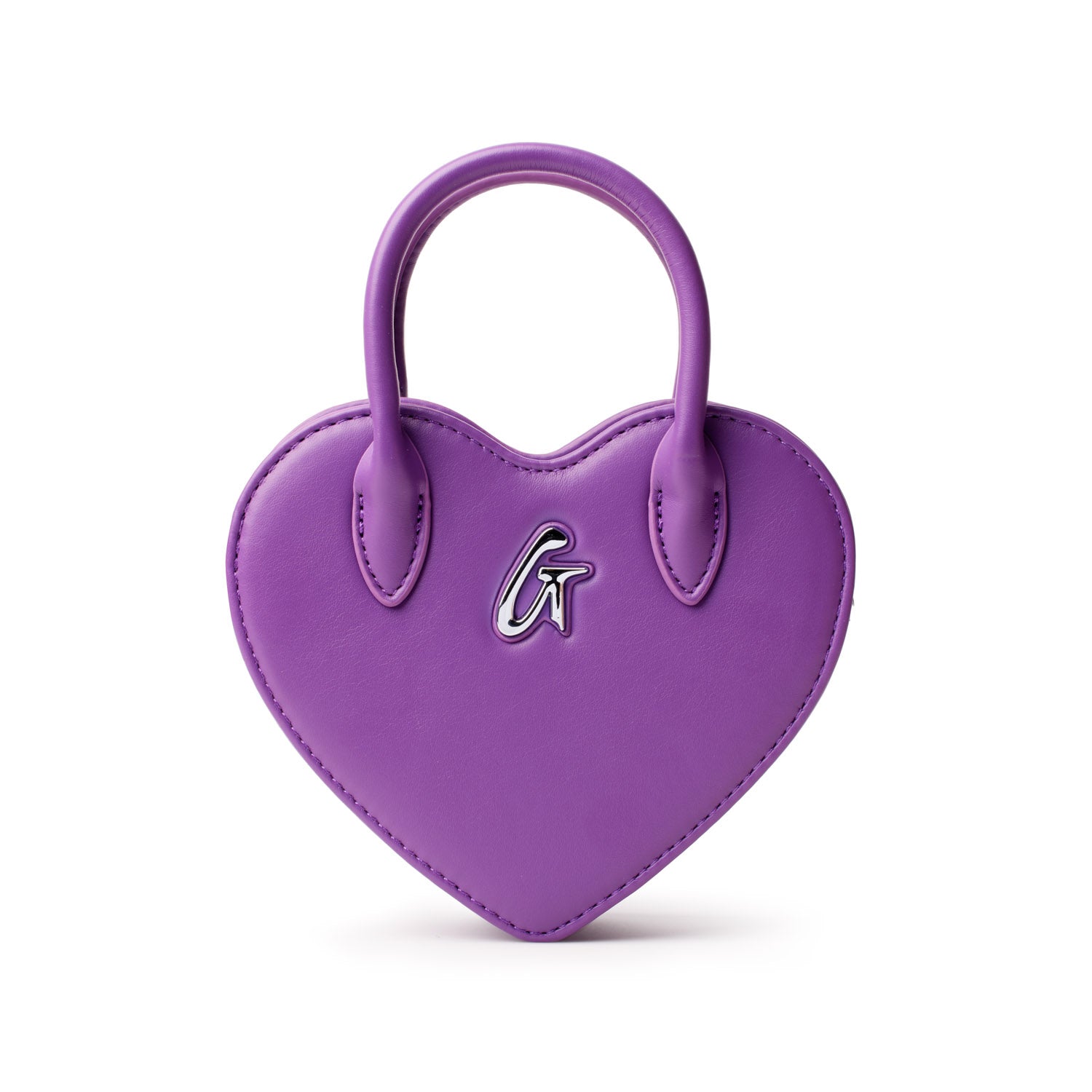 Purple heart-shaped bag with a silver "G" logo and top handle, designed for a stylish accessory.