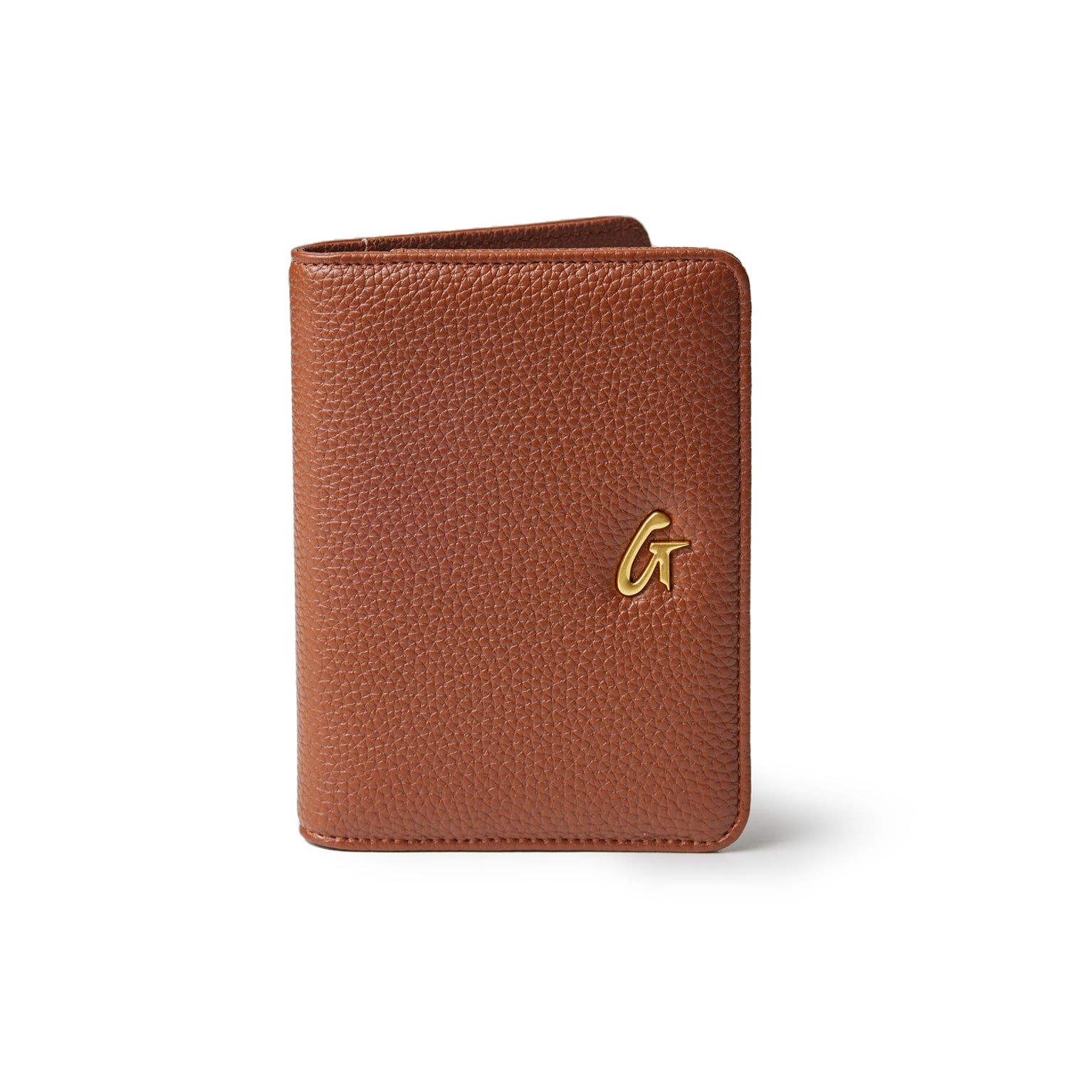 Brown Pebble leather passport holder with a gold logo accent, designed for travel convenience and style.