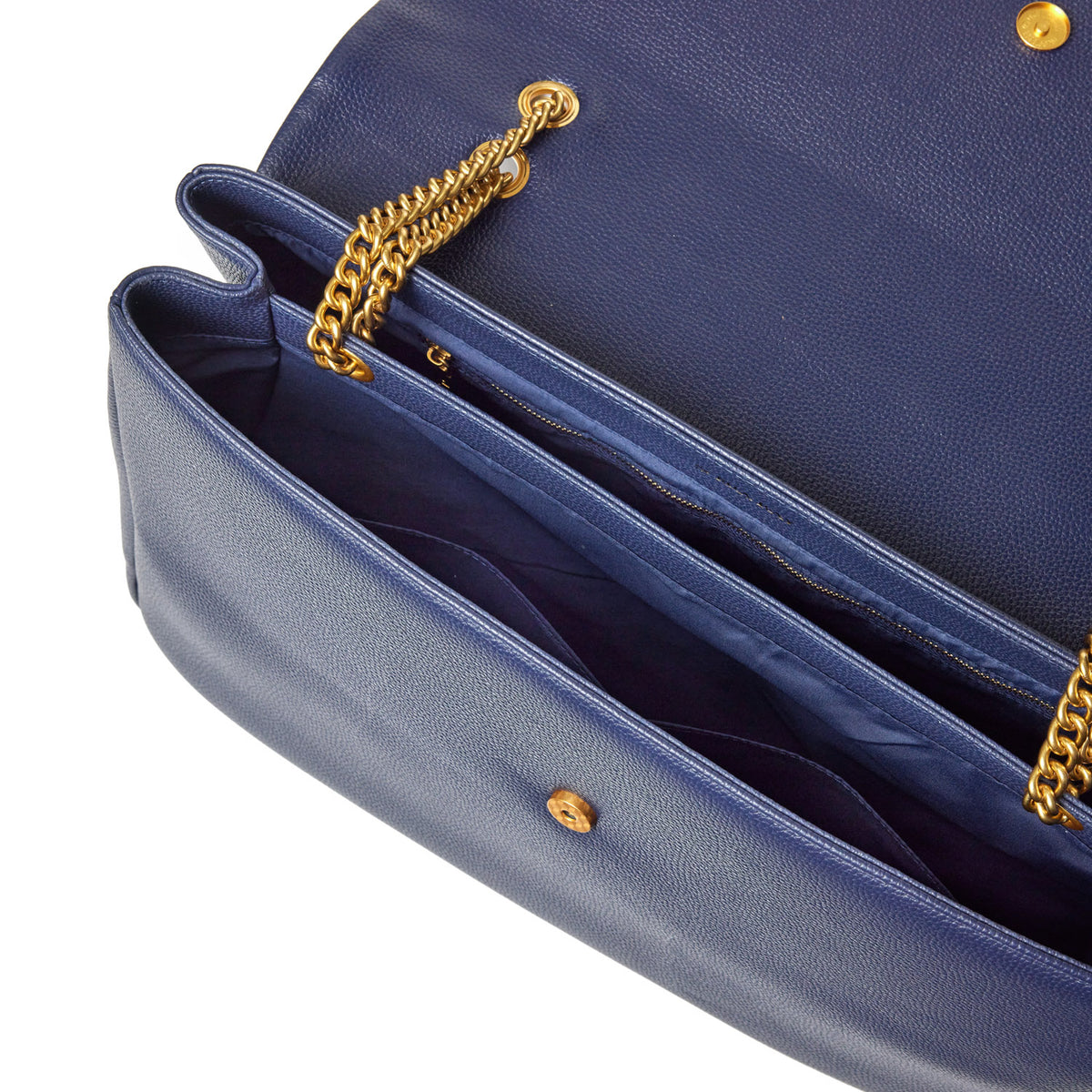 Open navy blue pebble leather flap bag with gold chain strap, interior compartments, and zipper pocket.