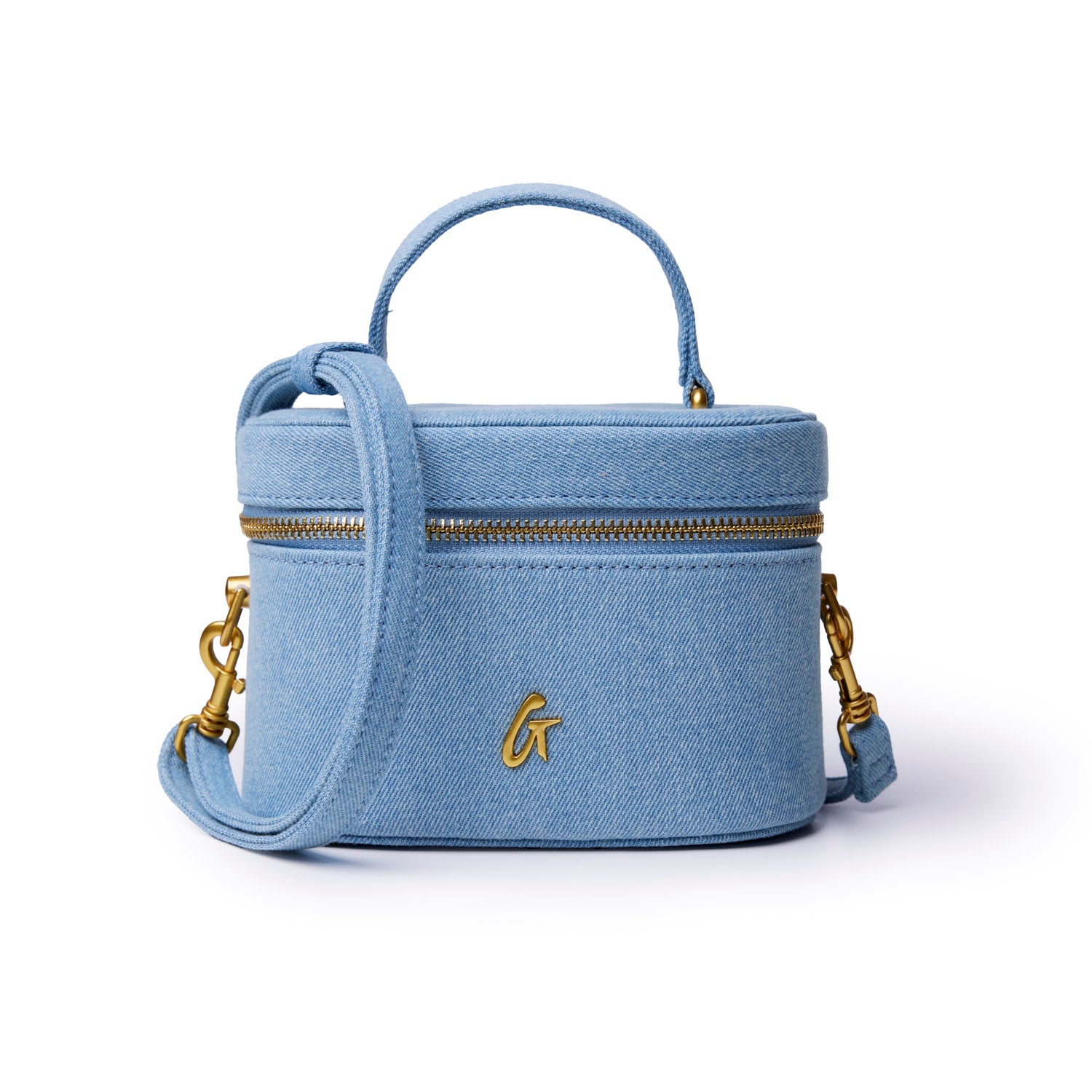 Mini denim gold vanity bag with a structured design, gold zipper, and detachable shoulder strap. Perfect for stylish storage.
