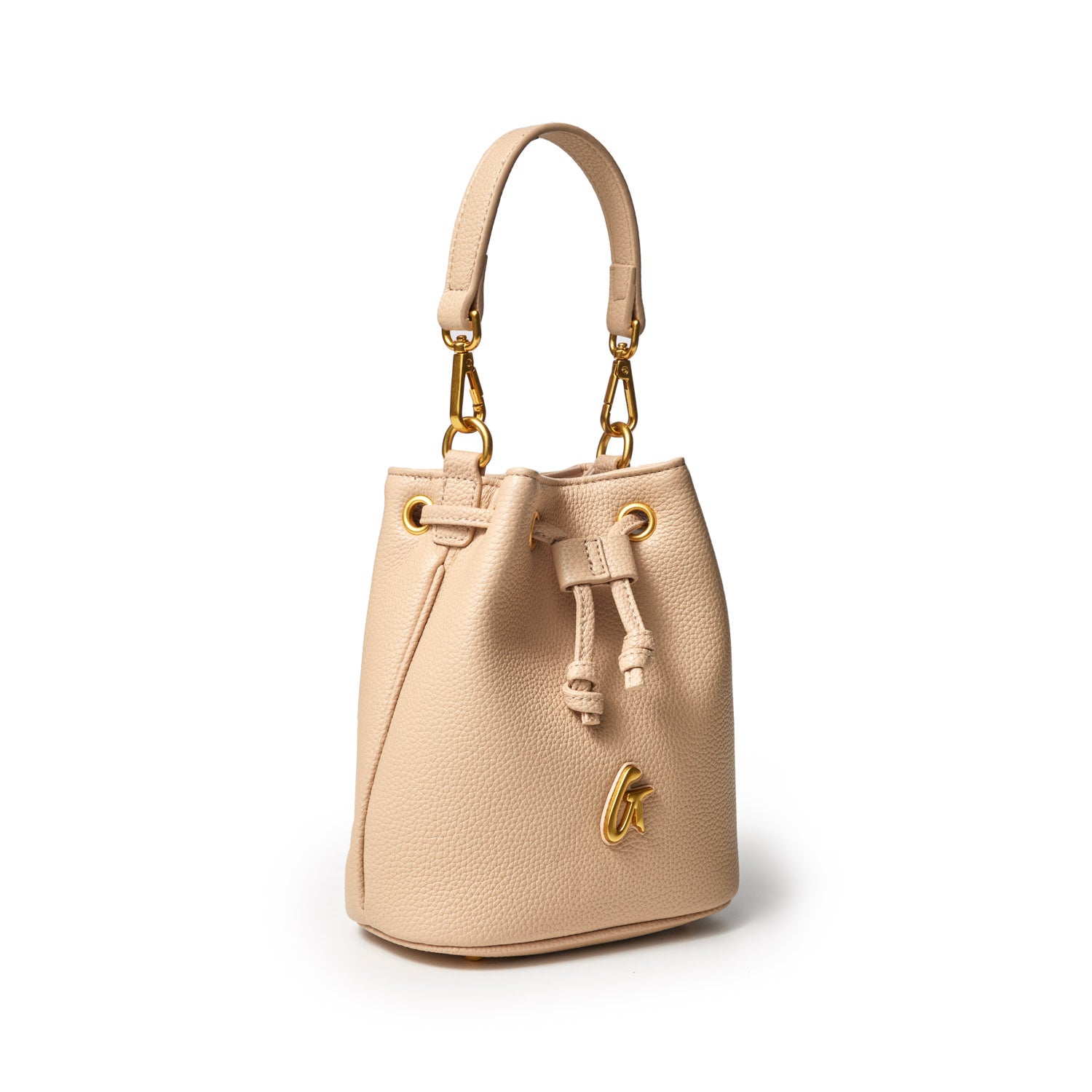 Mini pebble bucket bag in nude with gold hardware, adjustable strap, drawstring closure, and a small gold logo detail.
