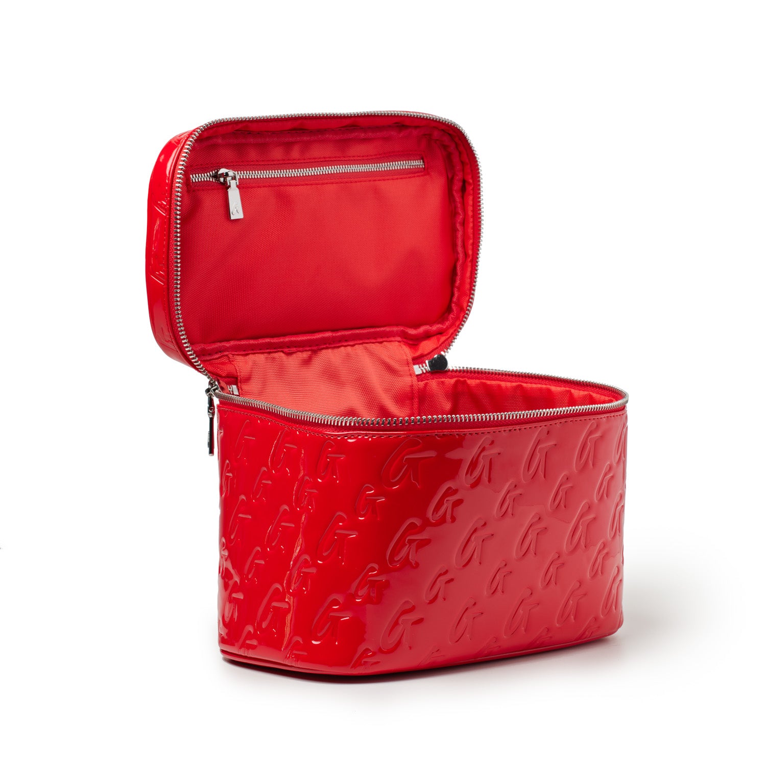 Red large monogram toiletry bag with embossed G pattern, open to show interior with zipper pocket and lining.