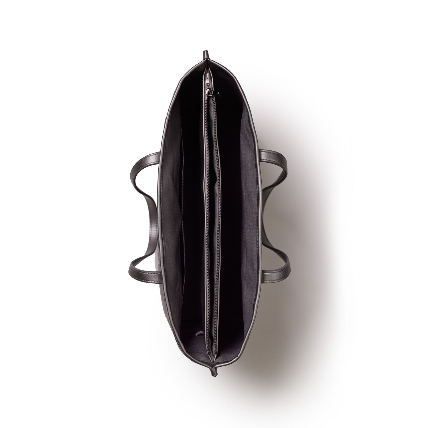 Top view of a black Monogram Sleek Tote in platinum with multiple compartments and a zipper pocket inside.