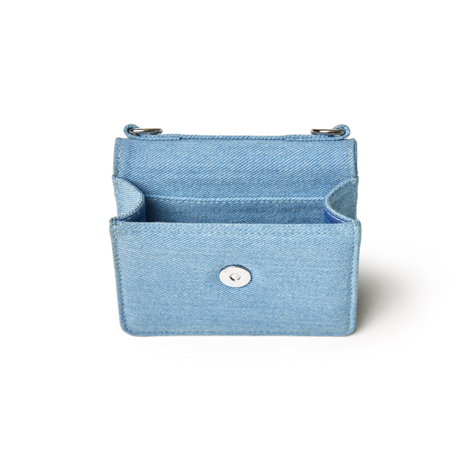 Mini denim silver WOC bag with a front snap closure, small size, and silver hardware, perfect for carrying essentials.