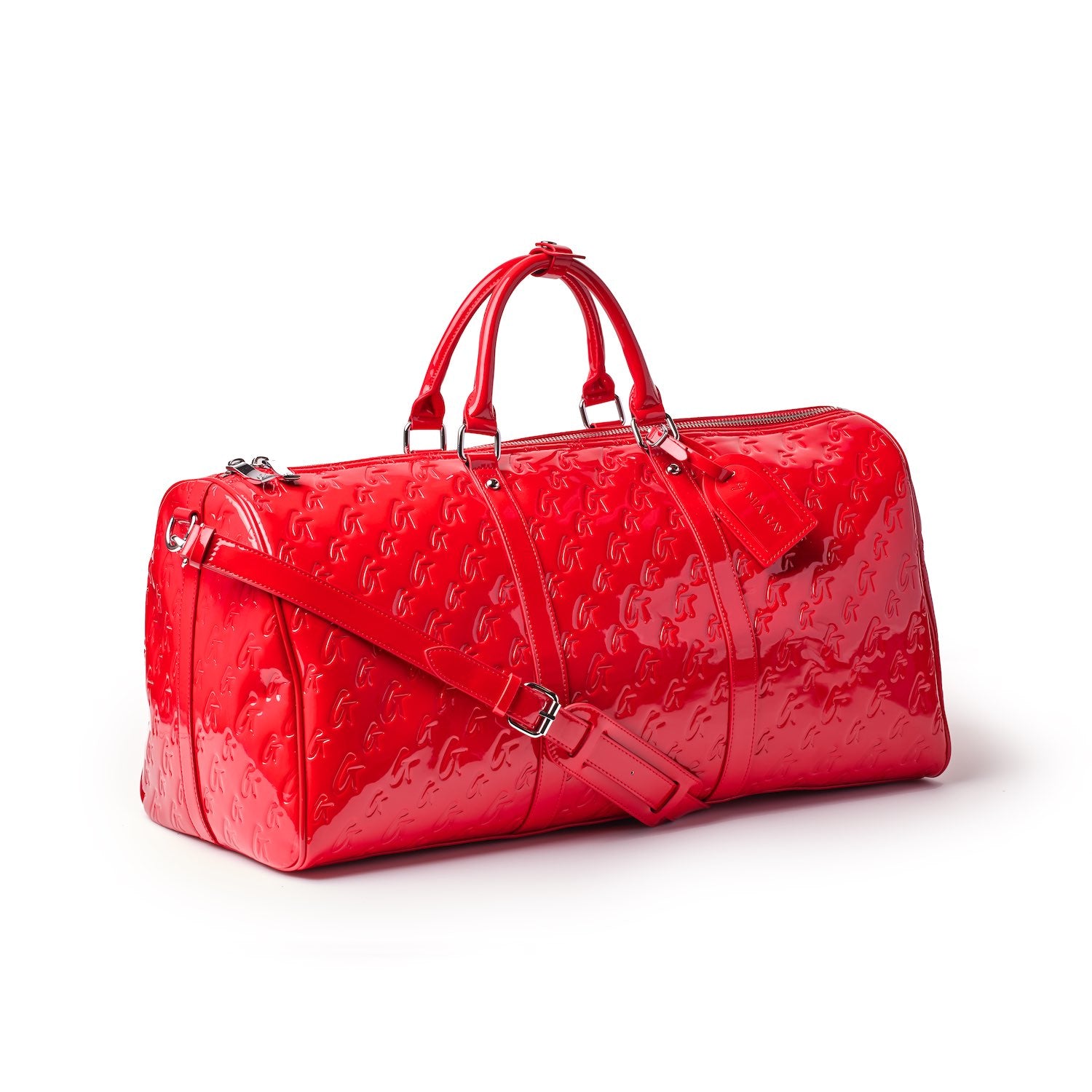 Red Monogram Duffle Bag with embossed logo pattern, dual top handles, adjustable shoulder strap, and zip closure.