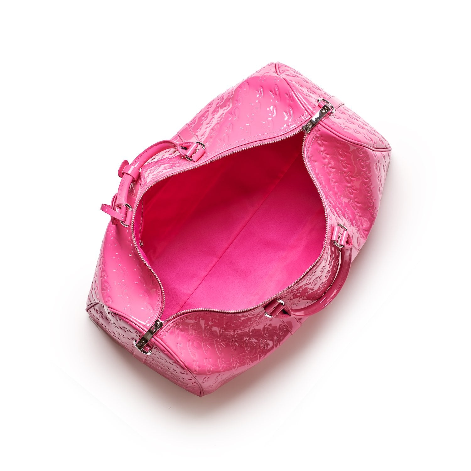 Open pink mirror hot pink monogram duffle bag with embossed pattern, silver zipper, and top handles, empty inside.