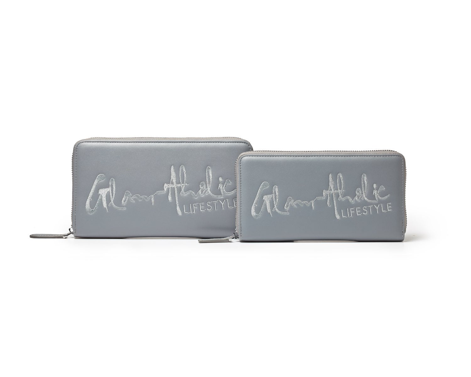 Gray signature logo wallets with "Glam Athletic Lifestyle" embroidered on the front, featuring silver zippers and sleek design.