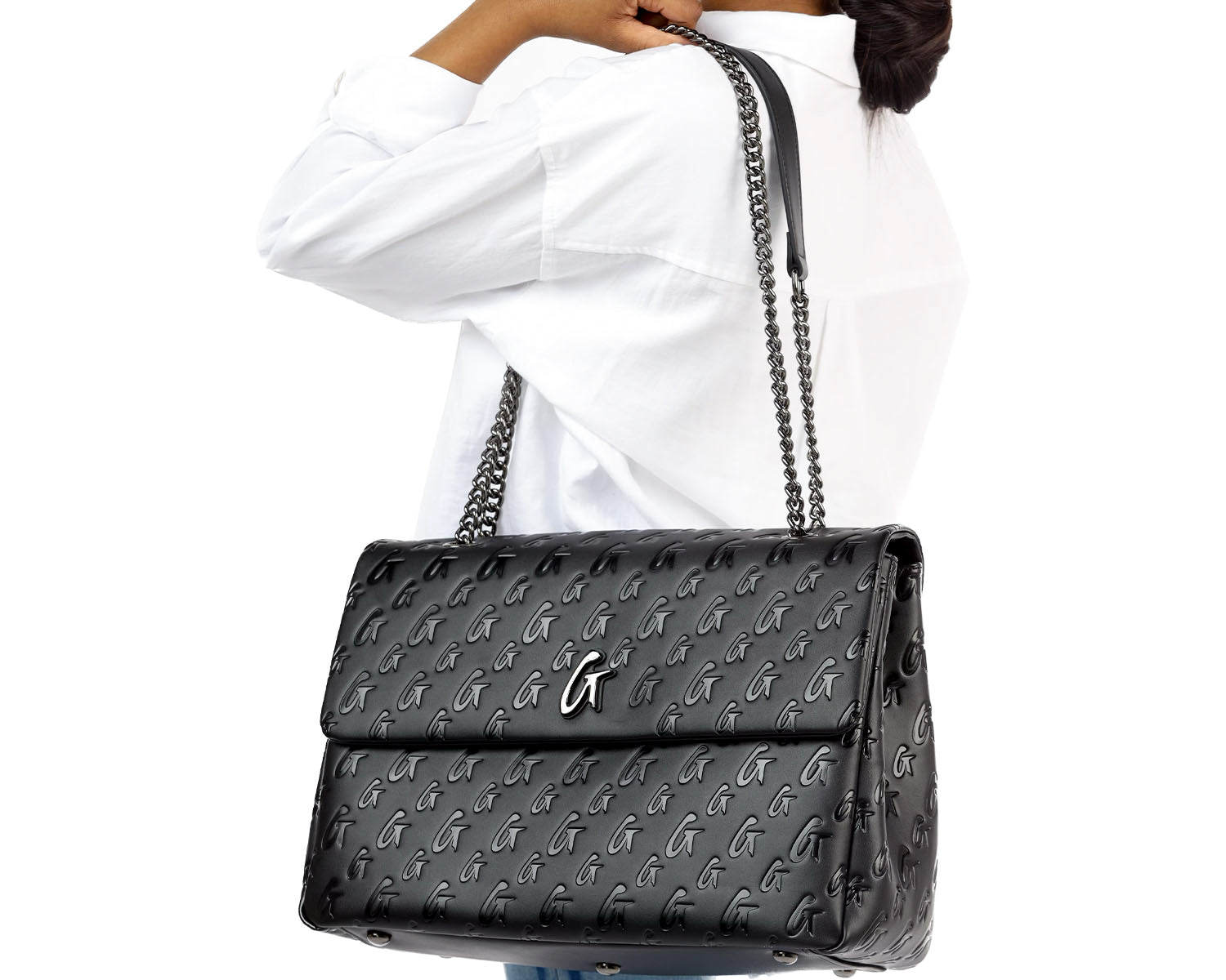 Black large monogram flap bag with chain strap, featuring a repeating logo pattern and a metallic logo clasp.