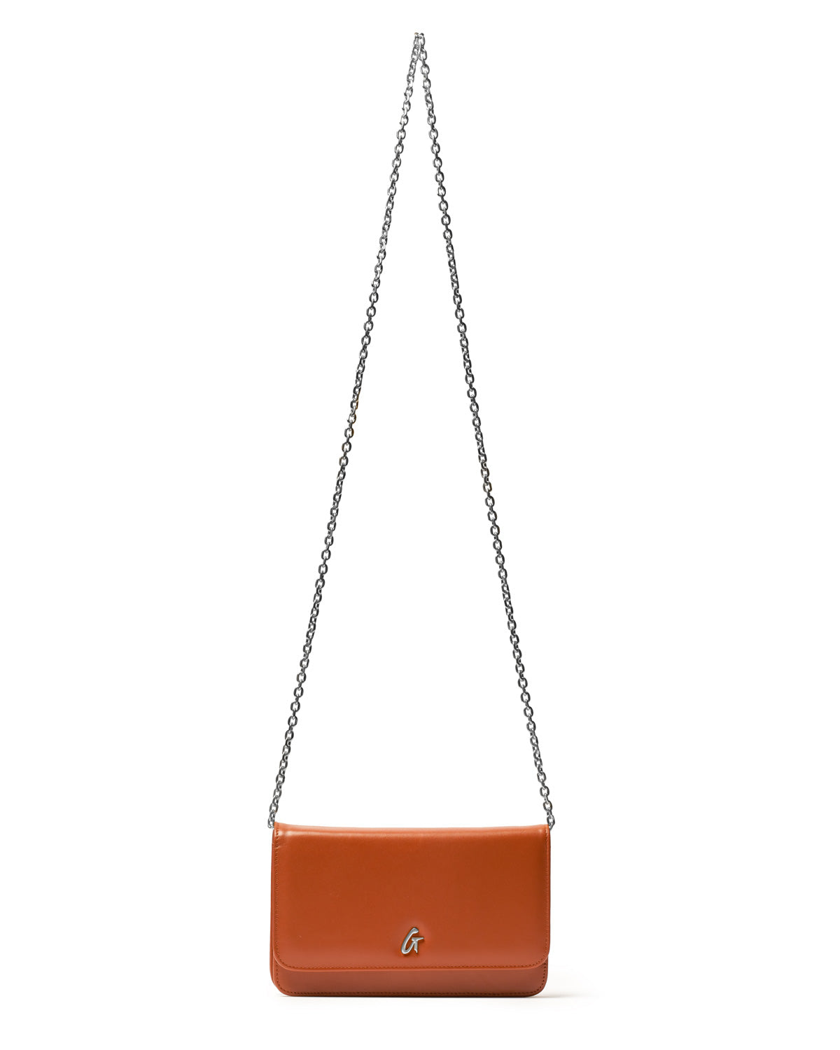 A brown leather shoulder bag with a silver chain strap and a silver "G" logo on the front, labeled as STANDARD SILVER WOC.