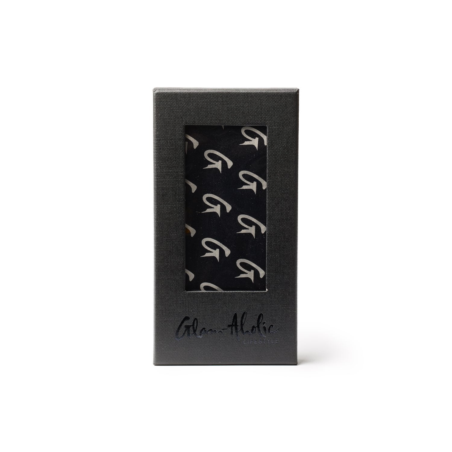 Black silk scarf with large monogram pattern, packaged in a sleek black box with a window display.