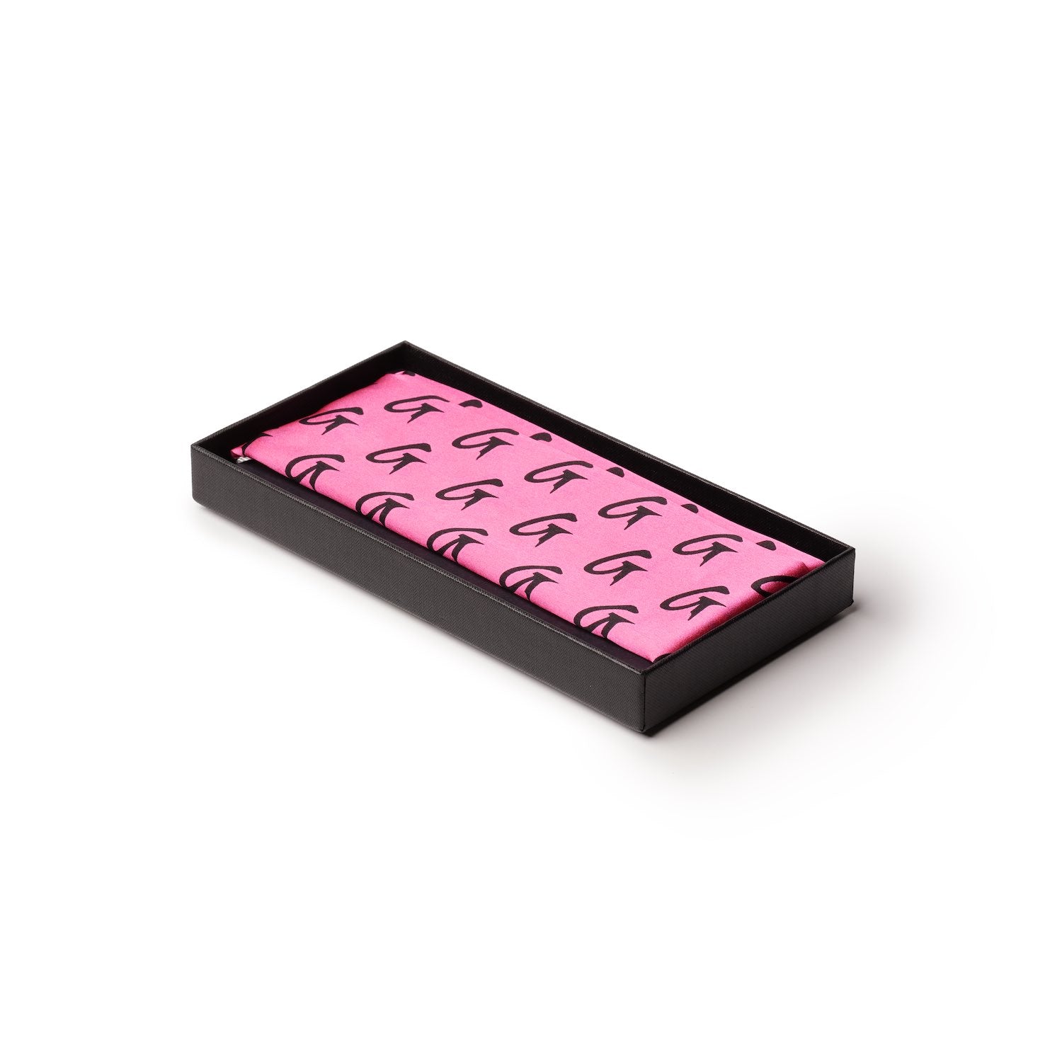 Medium pink silk scarf with black monogram pattern, neatly folded inside a black presentation box.