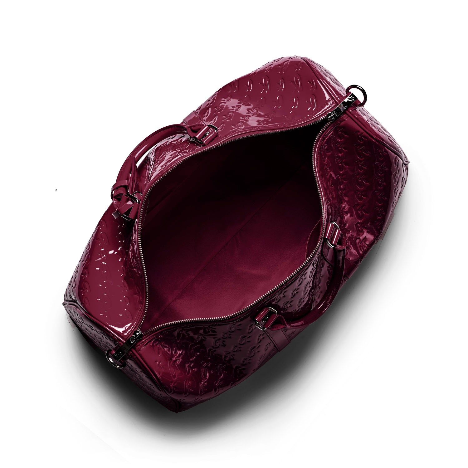 Spacious burgundy travel bag with a glossy finish and interior lining, perfect for stylish getaways.