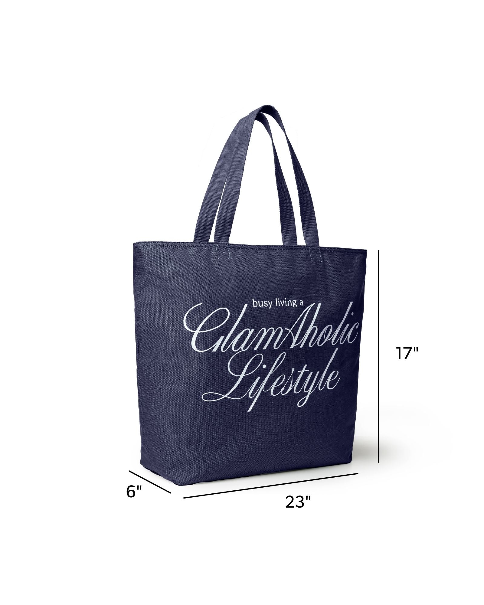 Navy canvas tote bag with "busy living a GlamAholic Lifestyle" text, measuring 23 inches wide and 17 inches tall.