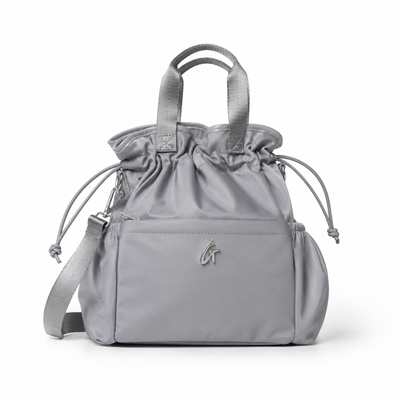 Gray nylon lunch bag with drawstring closure and adjustable straps, perfect for stylish and practical meal storage.