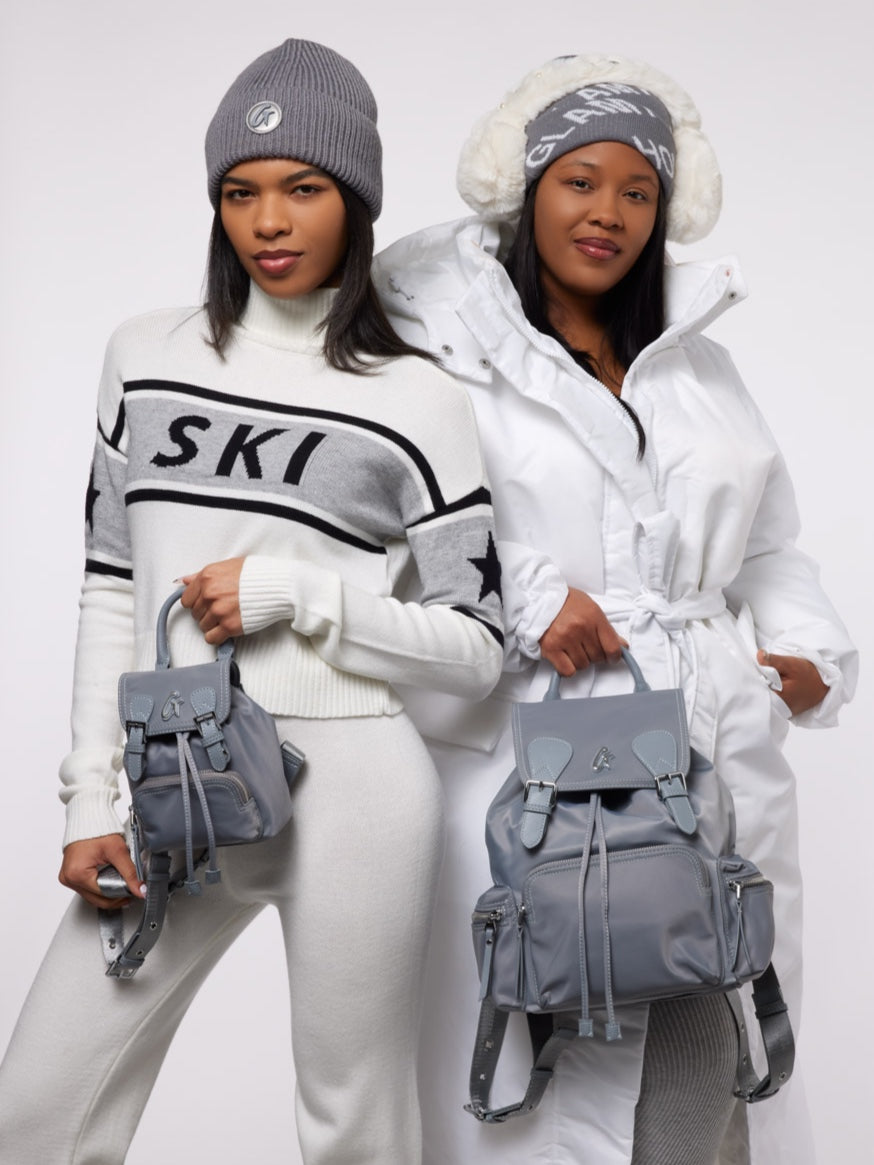 Gray mini nylon backpack showcased by two women in stylish winter outfits, highlighting its trendy and functional design.
