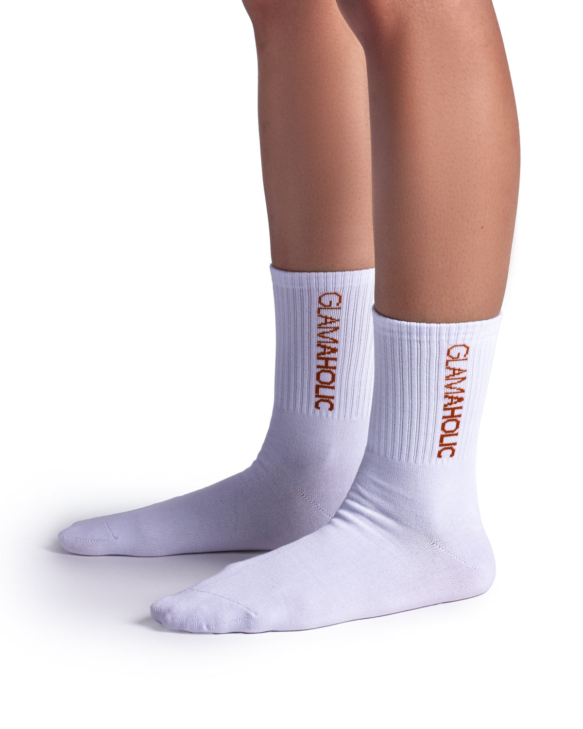 White athletic crew socks featuring "Glam-Aholic" branding in orange, perfect for sports and casual wear.