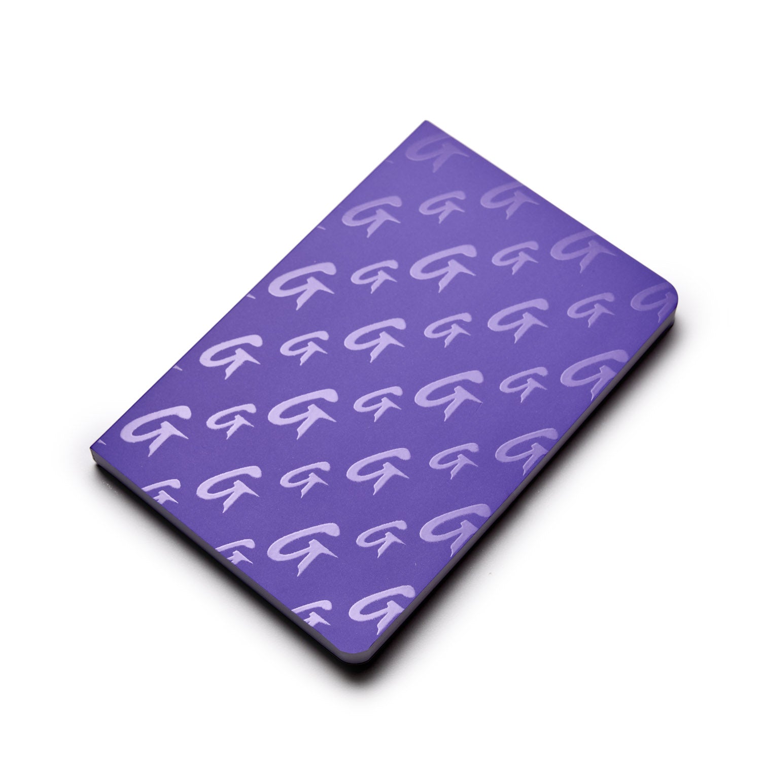 Purple monogram notebook with a repeating G logo pattern on the cover.