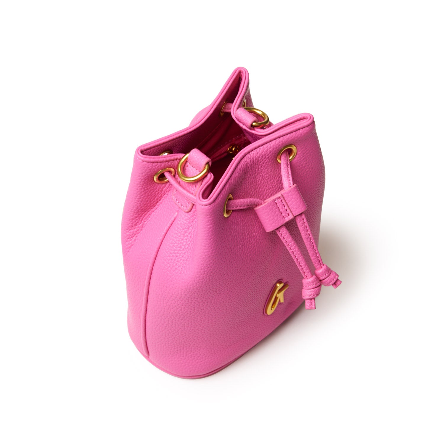 Pink pebble-textured bucket bag with gold hardware, drawstring closure, and adjustable strap, part of the Pebble Bucket Bag Bundle.