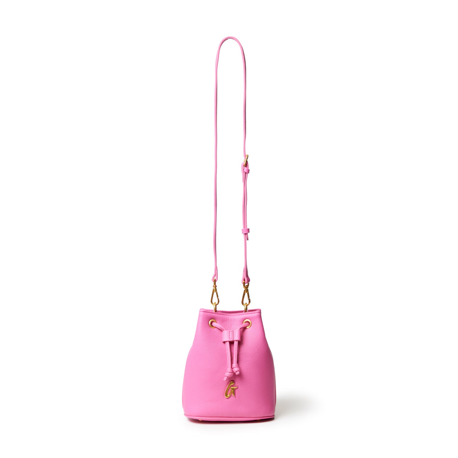 Pink pebble-textured bucket bag with a long adjustable strap, gold hardware, and a decorative gold "G" charm.