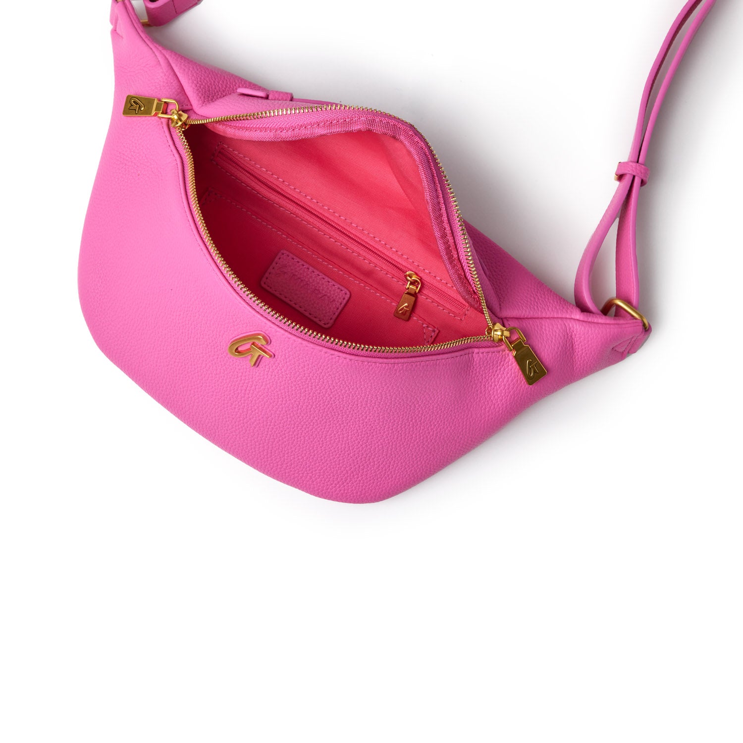 Pink pebble-textured fanny pack with gold zipper and logo, featuring an interior zip pocket and adjustable strap.