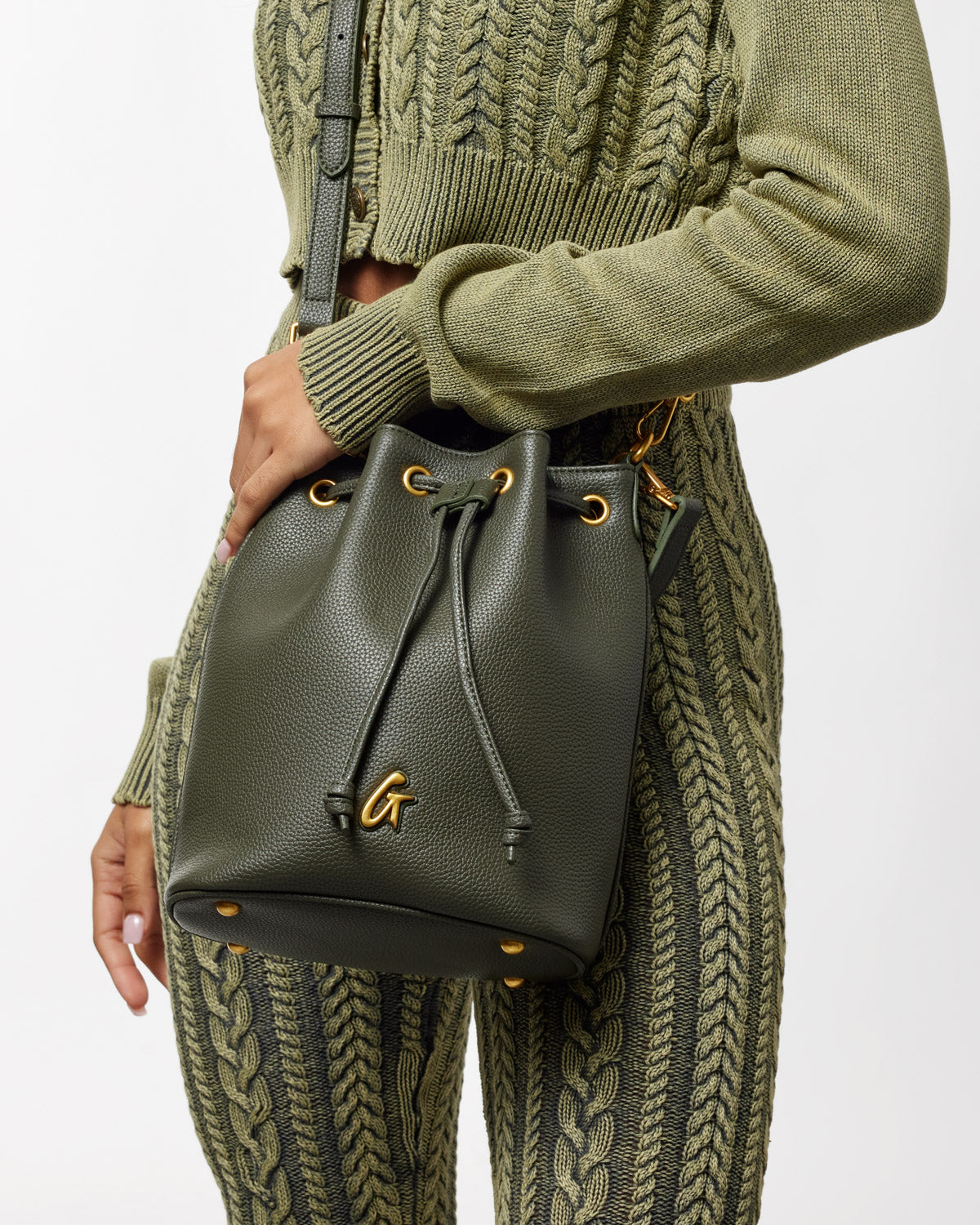 Medium olive green pebble bucket bag with gold hardware, drawstring closure, and adjustable strap.