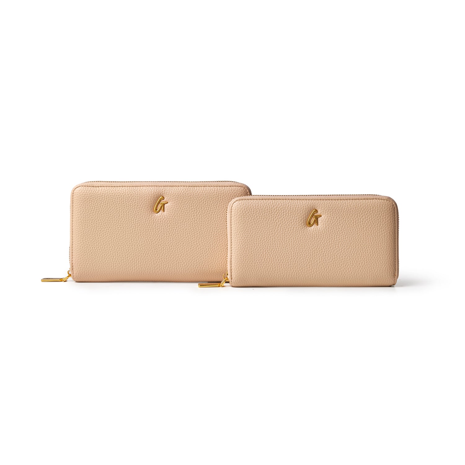 Two nude-colored jumbo pebble wallets with gold zipper pulls and a gold logo, displayed against a white background.