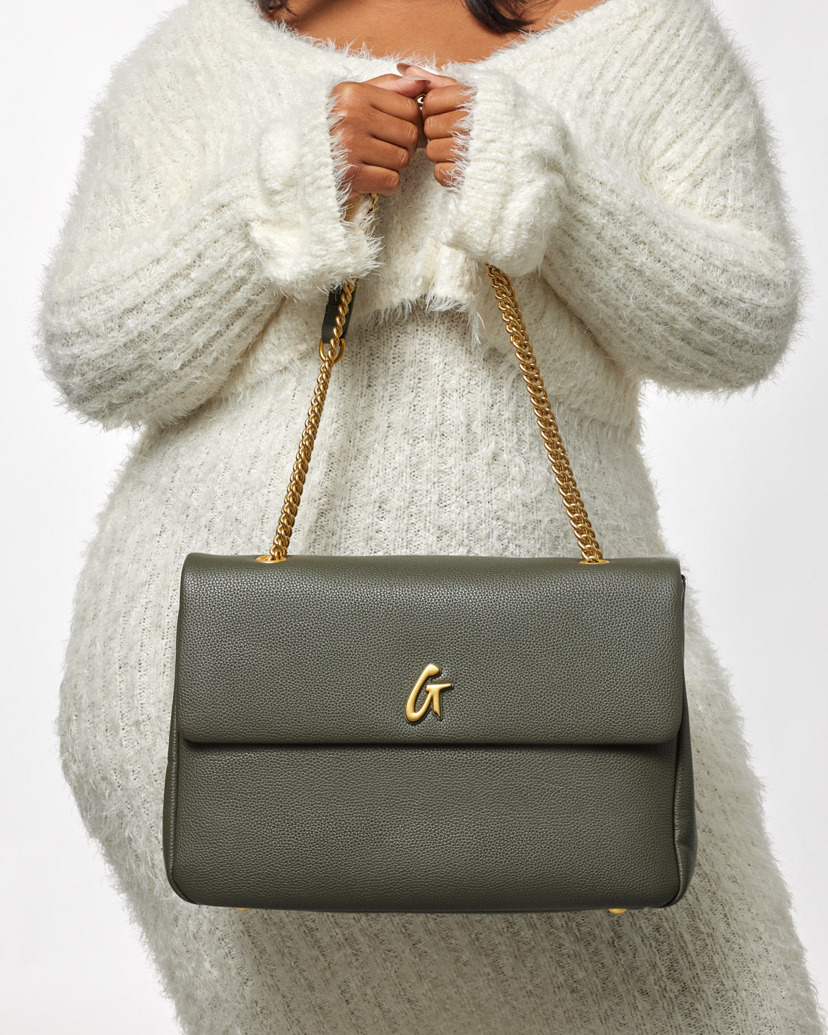 Large olive green pebble flap bag with a gold chain strap and a gold "G" logo on the front.