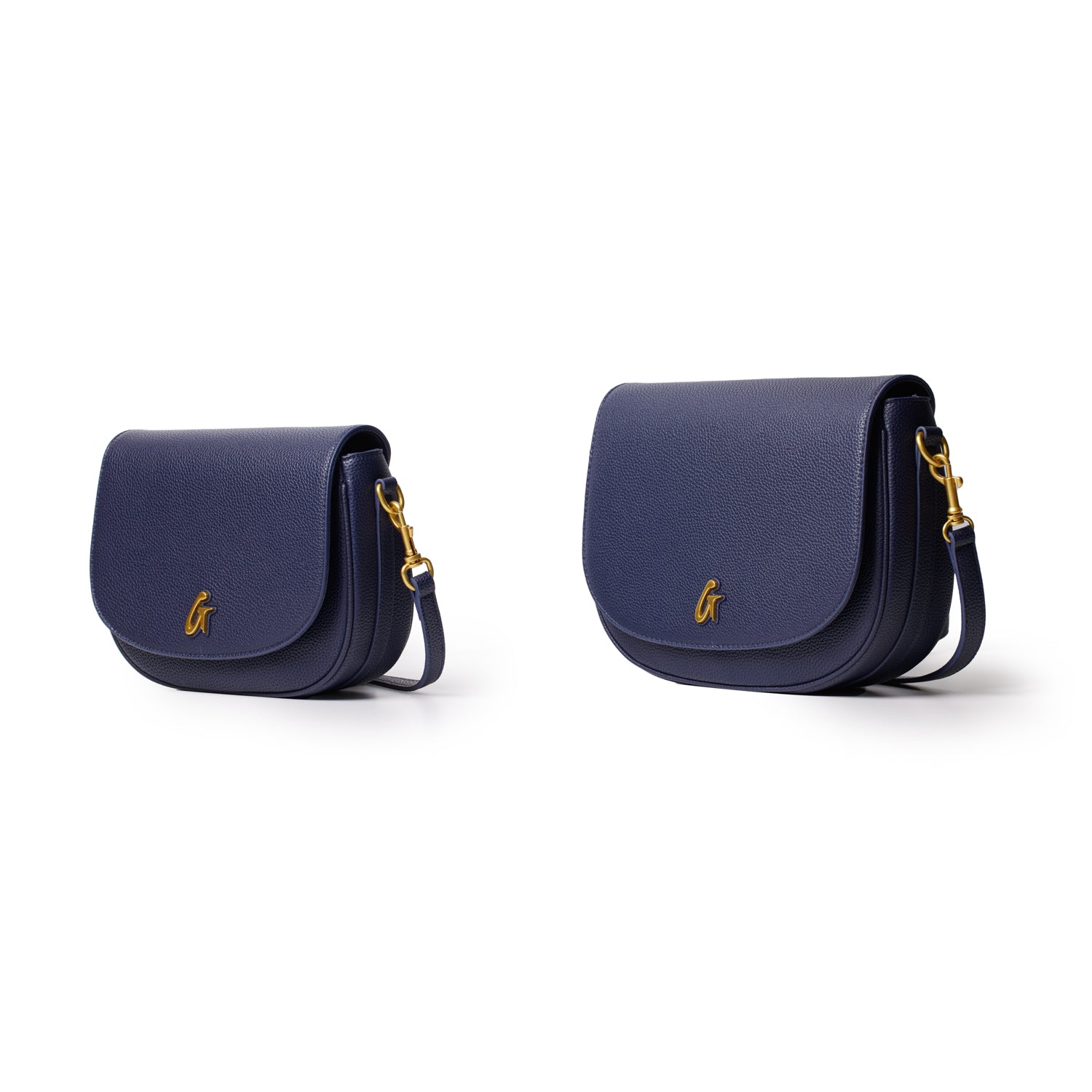 Two navy blue pebble leather shoulder bags, medium and small size, with gold hardware and a gold logo on the front flap.