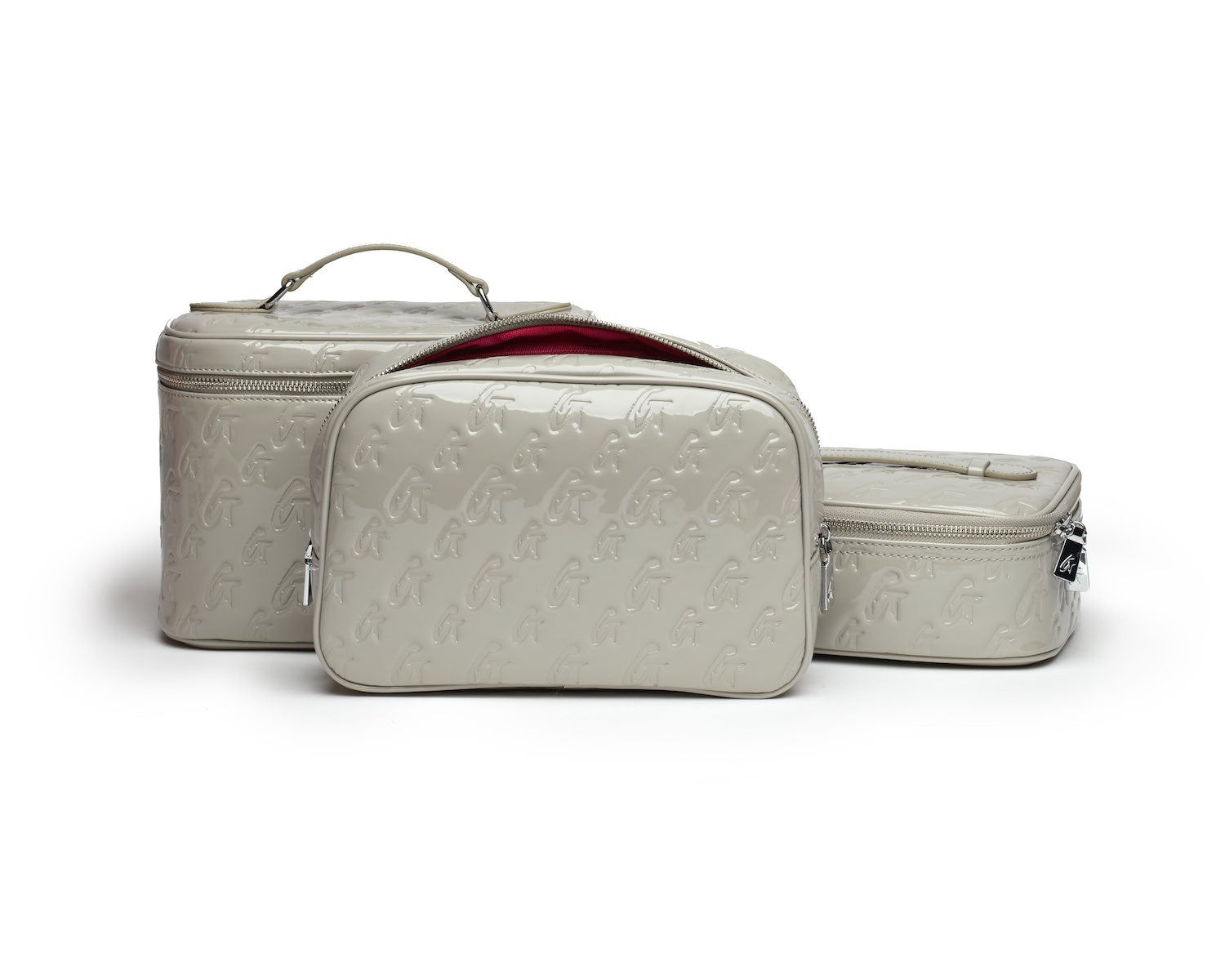 Small monogram toiletry bag in mirror gray with embossed logo pattern, zip closures, and a red interior lining.