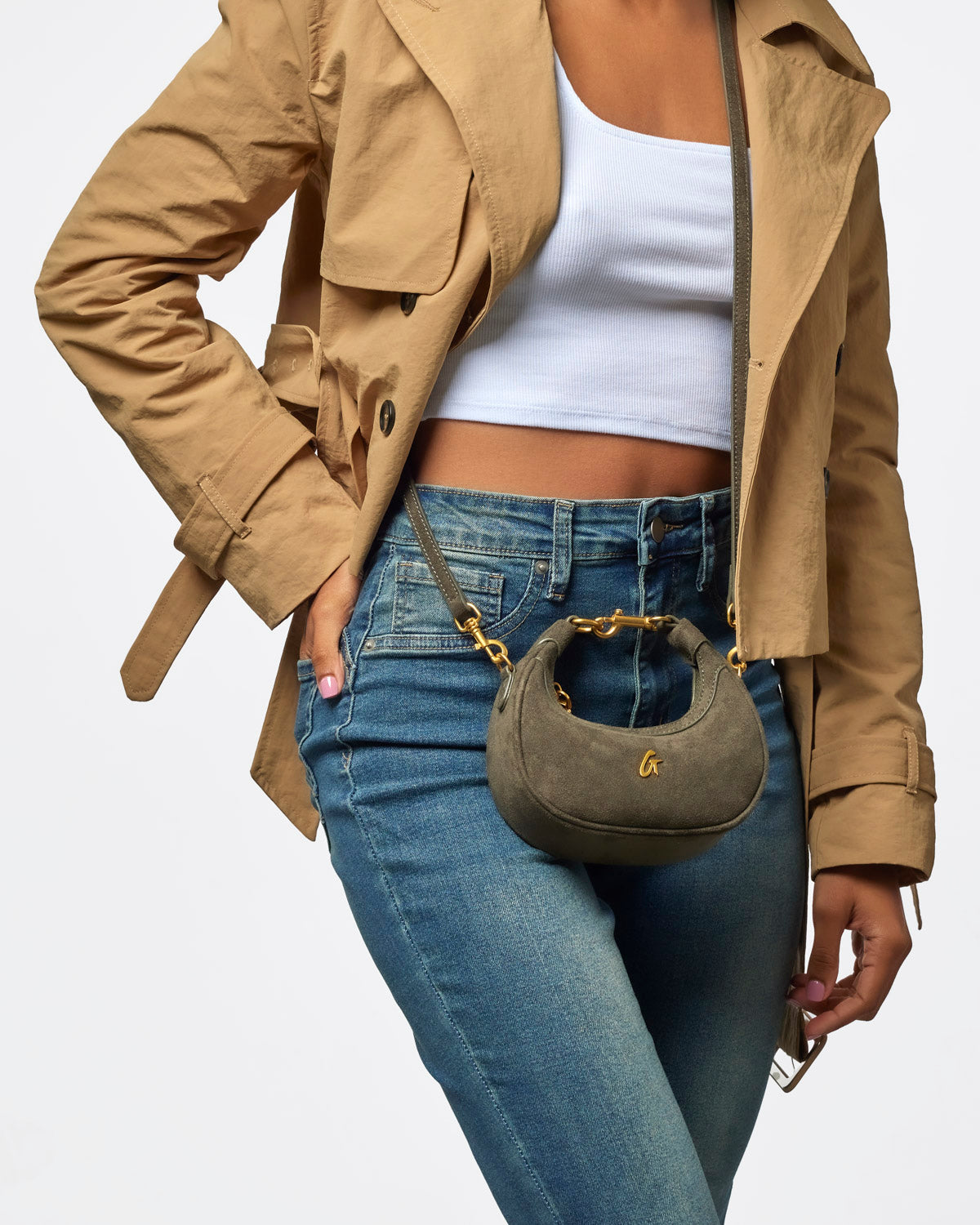 Olive green nano suede hobo bag styled with a casual outfit, featuring a curved shape and gold hardware accents.