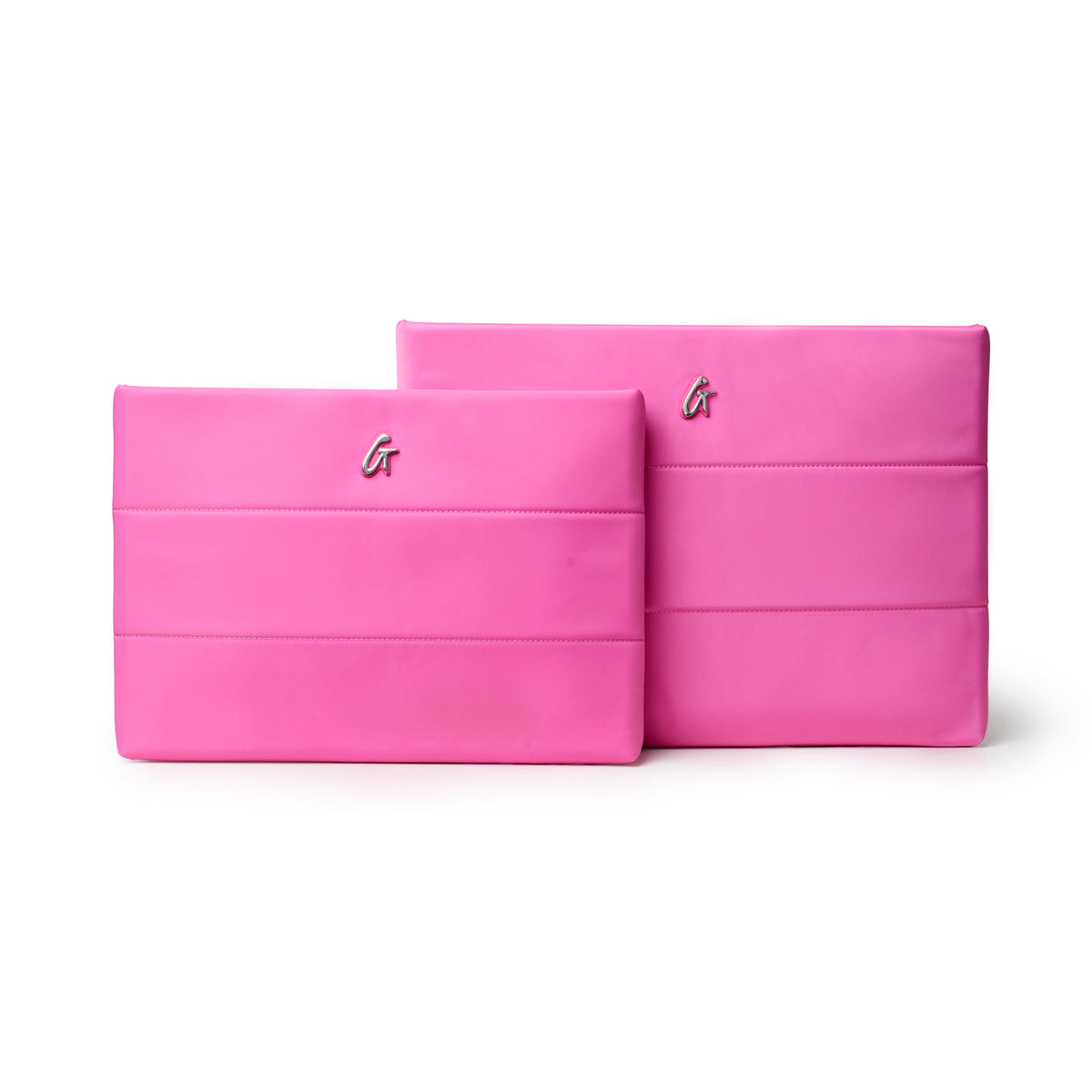Hot pink nylon laptop sleeves in two sizes featuring a sleek design and logo, perfect for stylish protection.