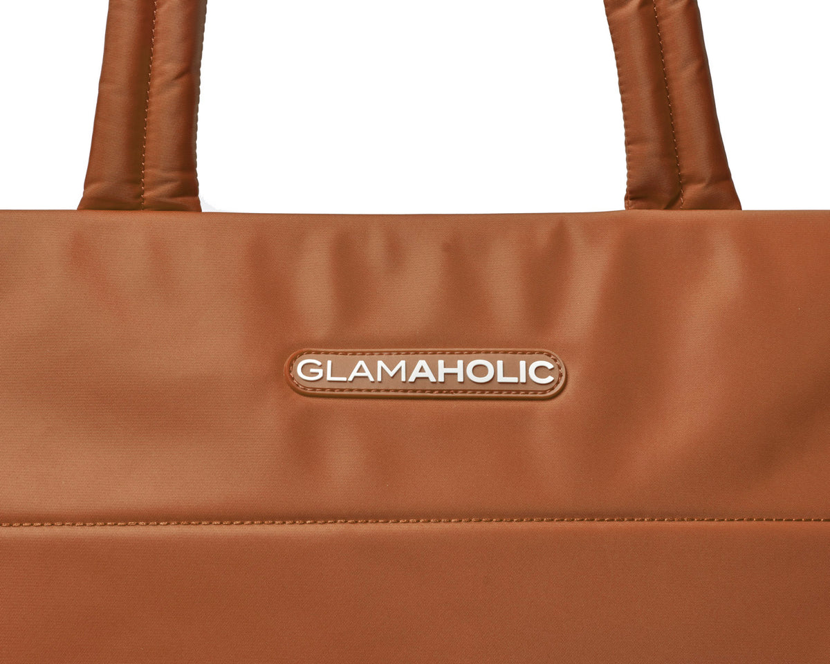 Brown athletic nylon tote featuring a sleek design and the Glam-Aholic logo for stylish functionality.