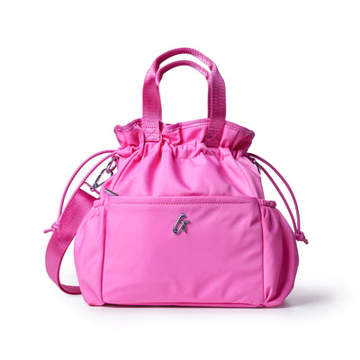 Hot pink nylon lunch bag with adjustable straps and a drawstring closure, perfect for stylish on-the-go meals.