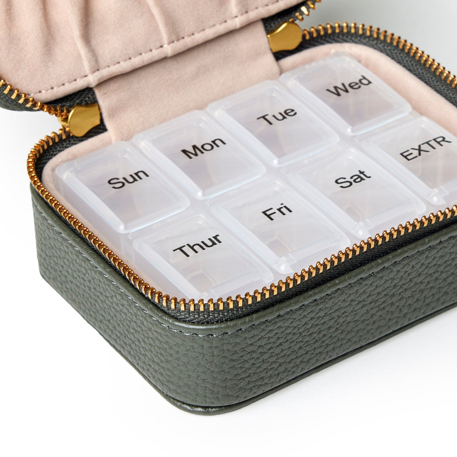 Olive green pebble pill case with zip closure, featuring clear compartments labeled for each day of the week.
