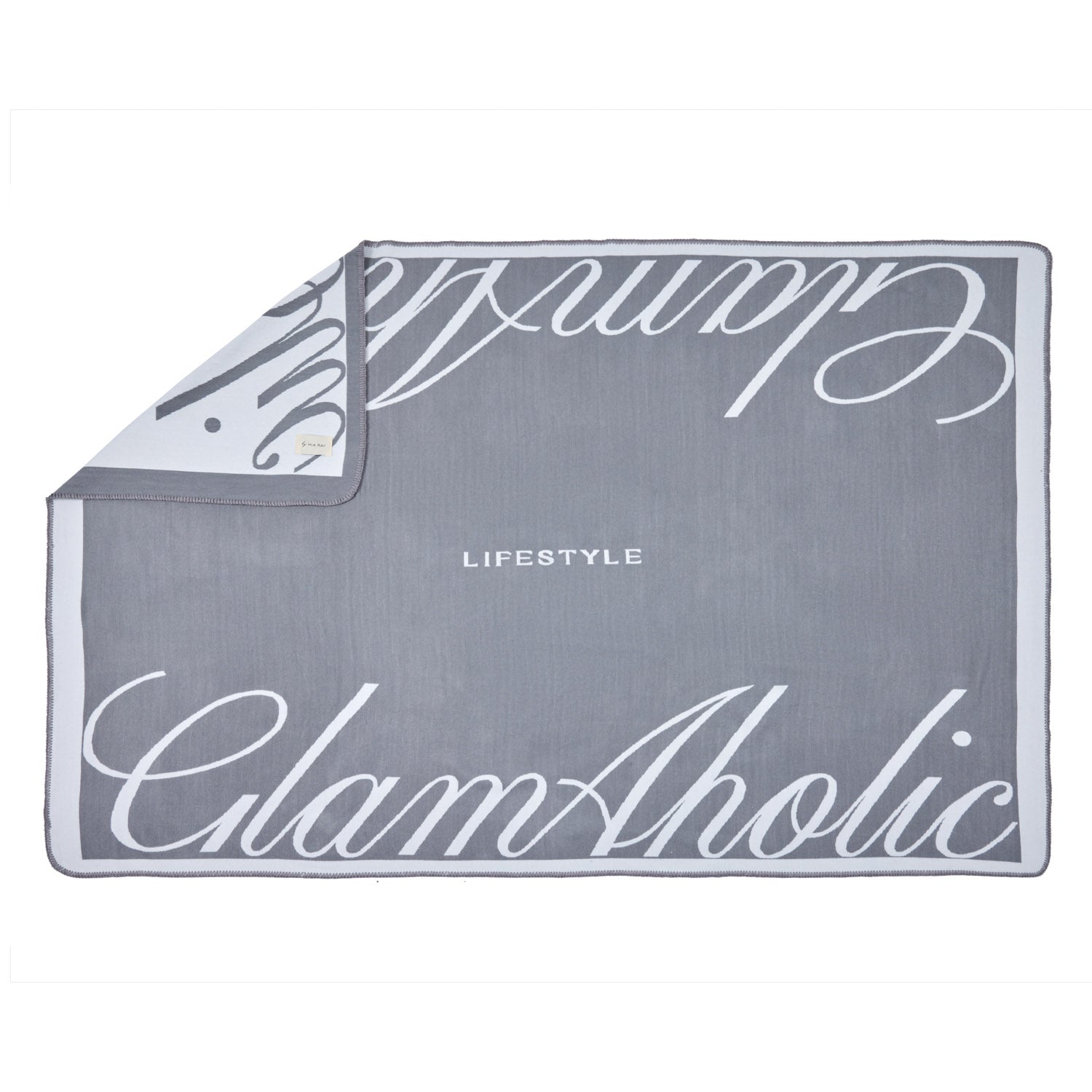 Gray luxury throw blanket with white script text, featuring "Signature Logo Luxe Throw Blanket" and "Chic" design elements.