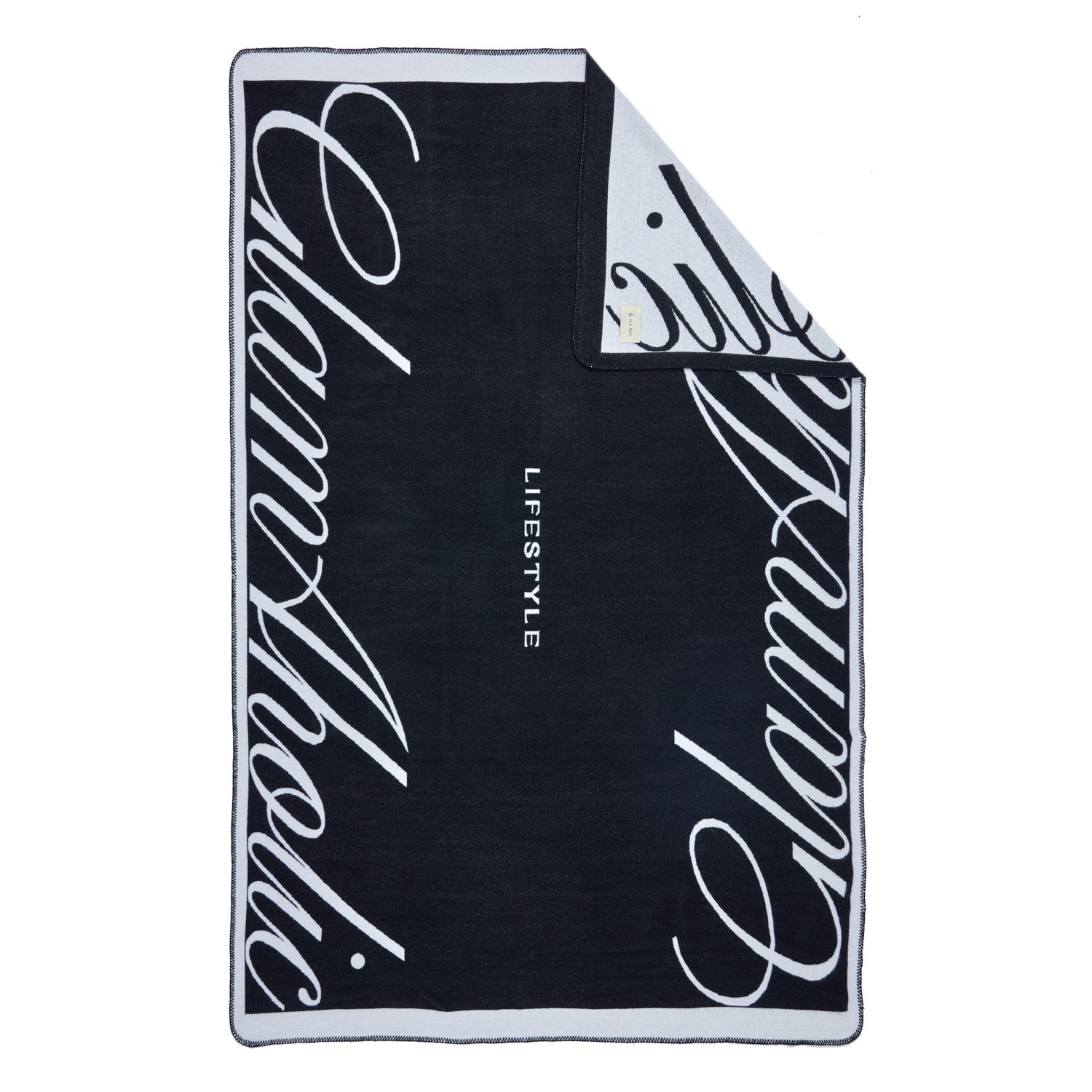 Black luxury throw blanket with bold white cursive "Signature Logo" text and "LIFESTYLE" in the center.