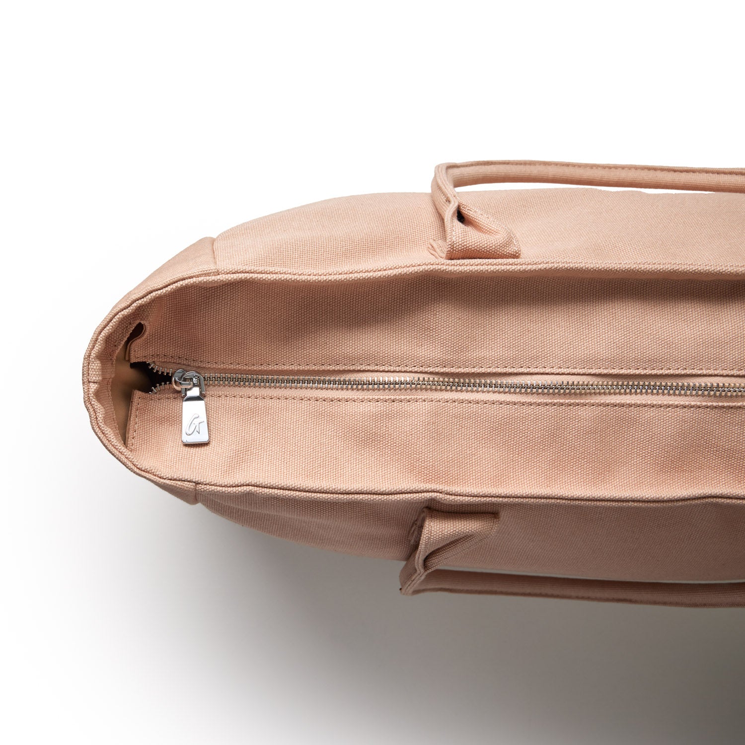 Nude athletic canvas tote bag featuring a zippered top and sturdy handles for versatile everyday use.