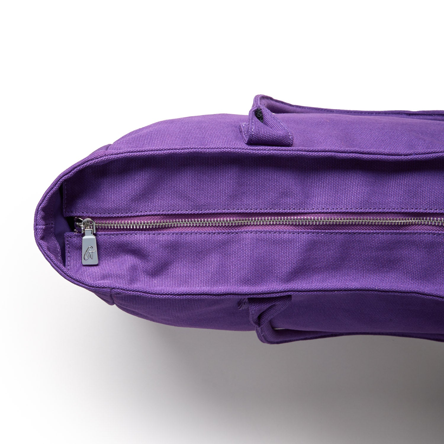 Purple athletic canvas tote with a zippered closure, showcasing a durable design for versatile use.