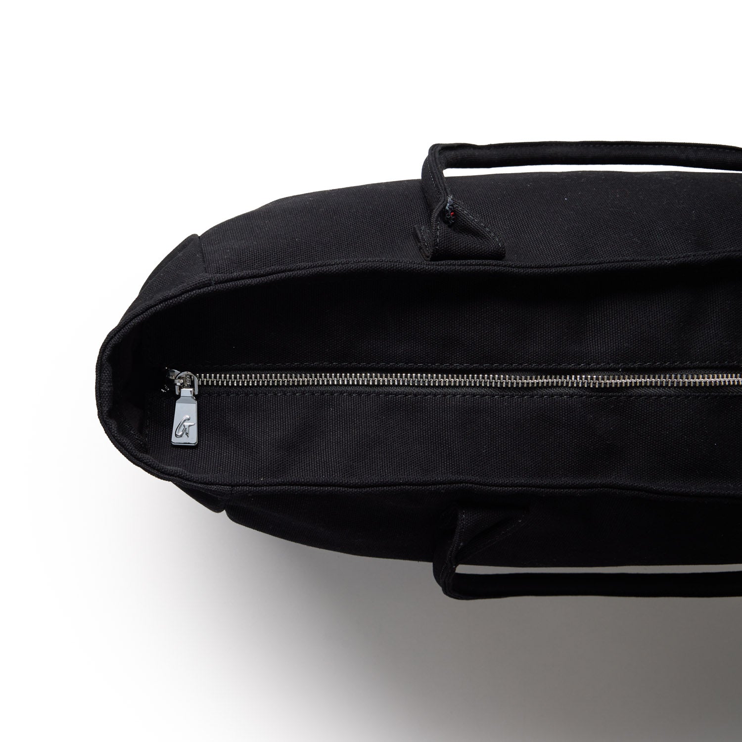Black athletic canvas tote bag with a zippered closure and sturdy handles, ideal for gym or everyday use.
