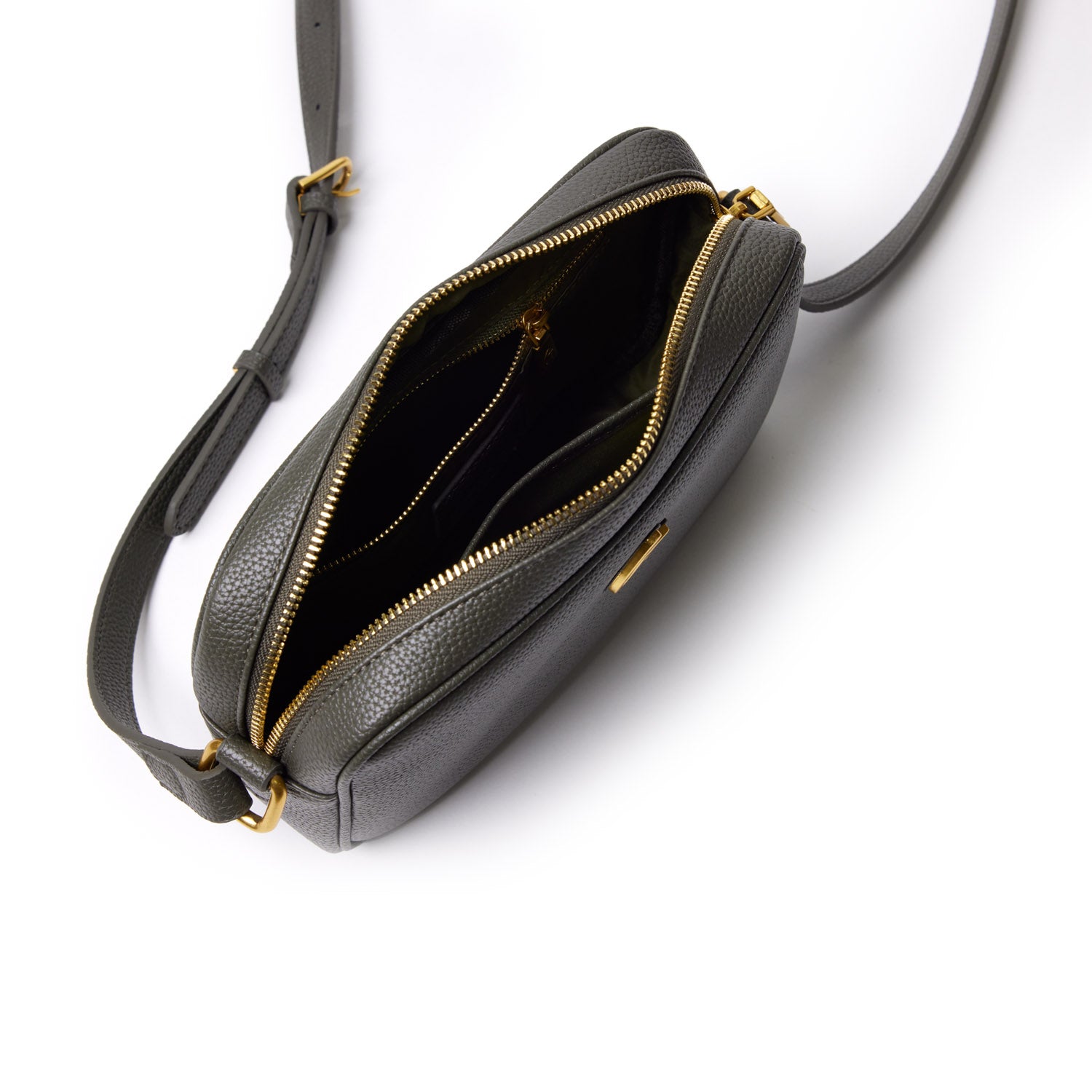 Olive green Pebble Camera Bag with gold zippers, open to show multiple compartments, adjustable strap, and compact design.