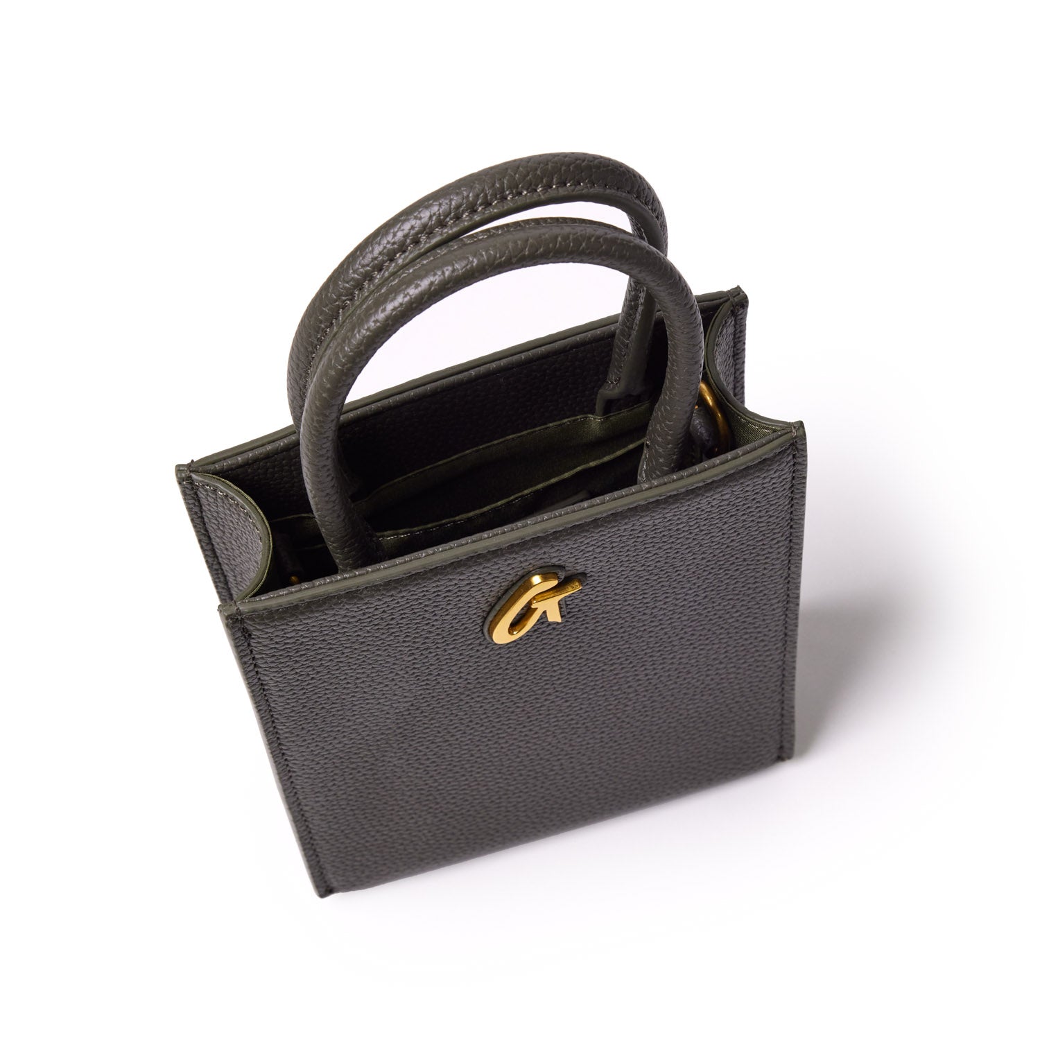 Mini pebble tote bag in olive green with textured leather, dual handles, and gold-tone logo detail on the front.