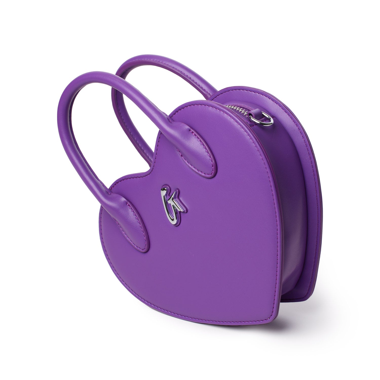Purple heart-shaped handbag with dual handles, silver logo detail, and zip closure, stylish and compact accessory.