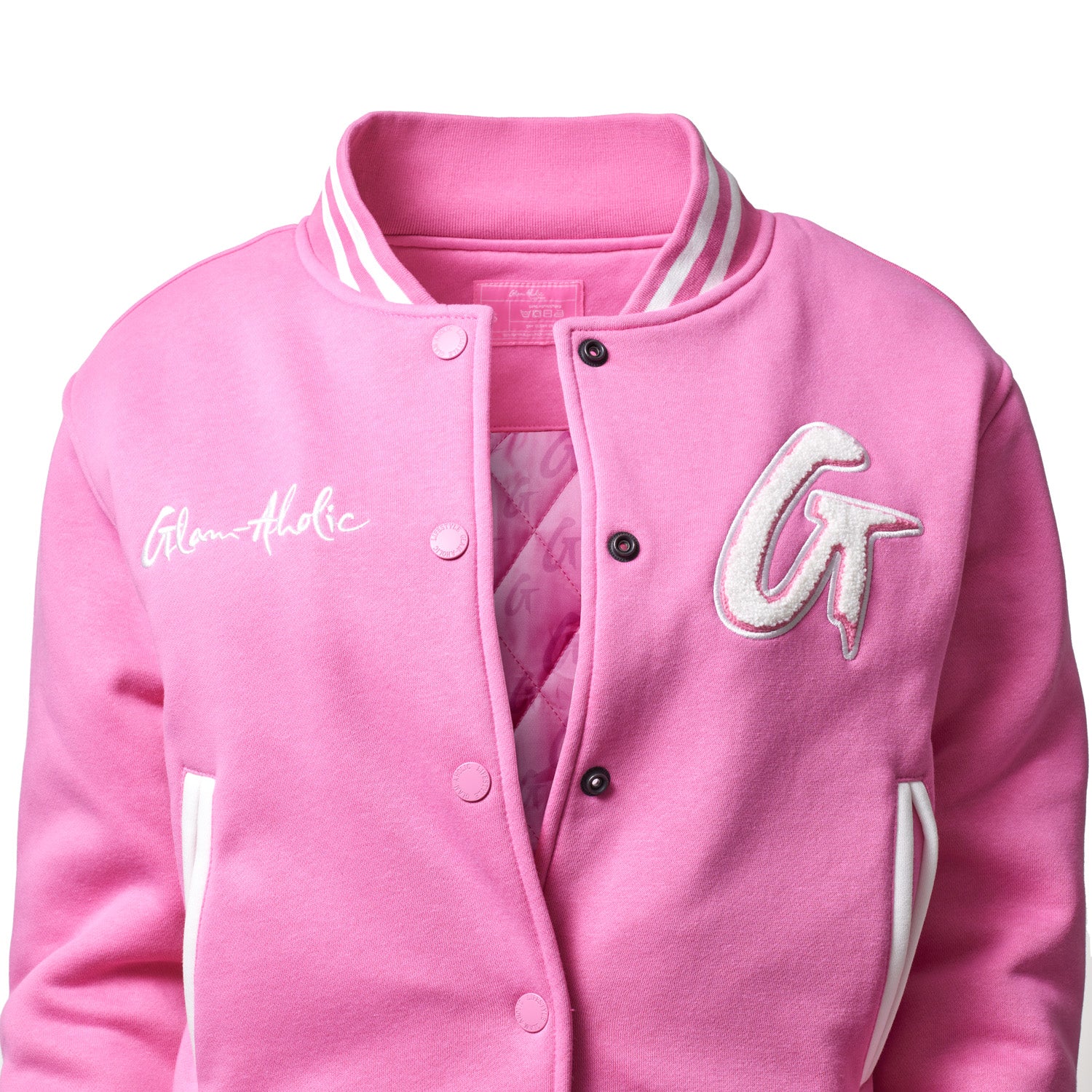 Pink varsity jacket with white accents, embroidered "Glam-athic" text, and large "GT" patch on the chest.