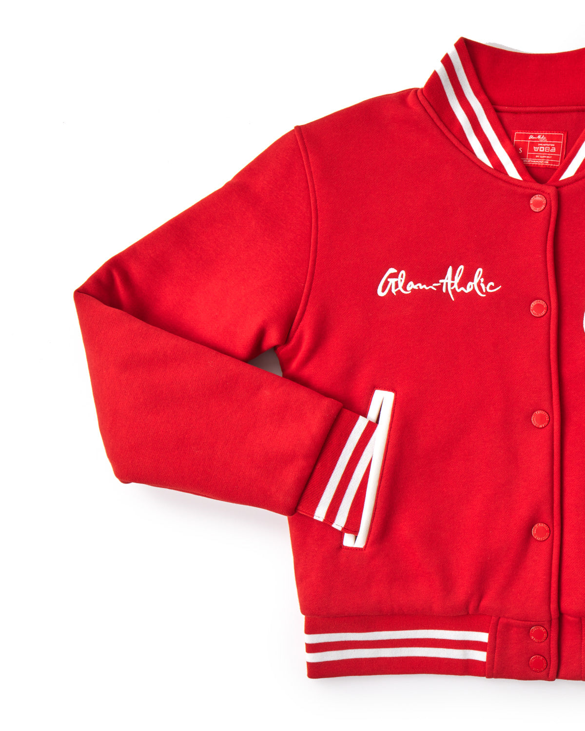 Red varsity jacket with white striped accents, embroidered "Glam-aholic" text, and snap button closure.