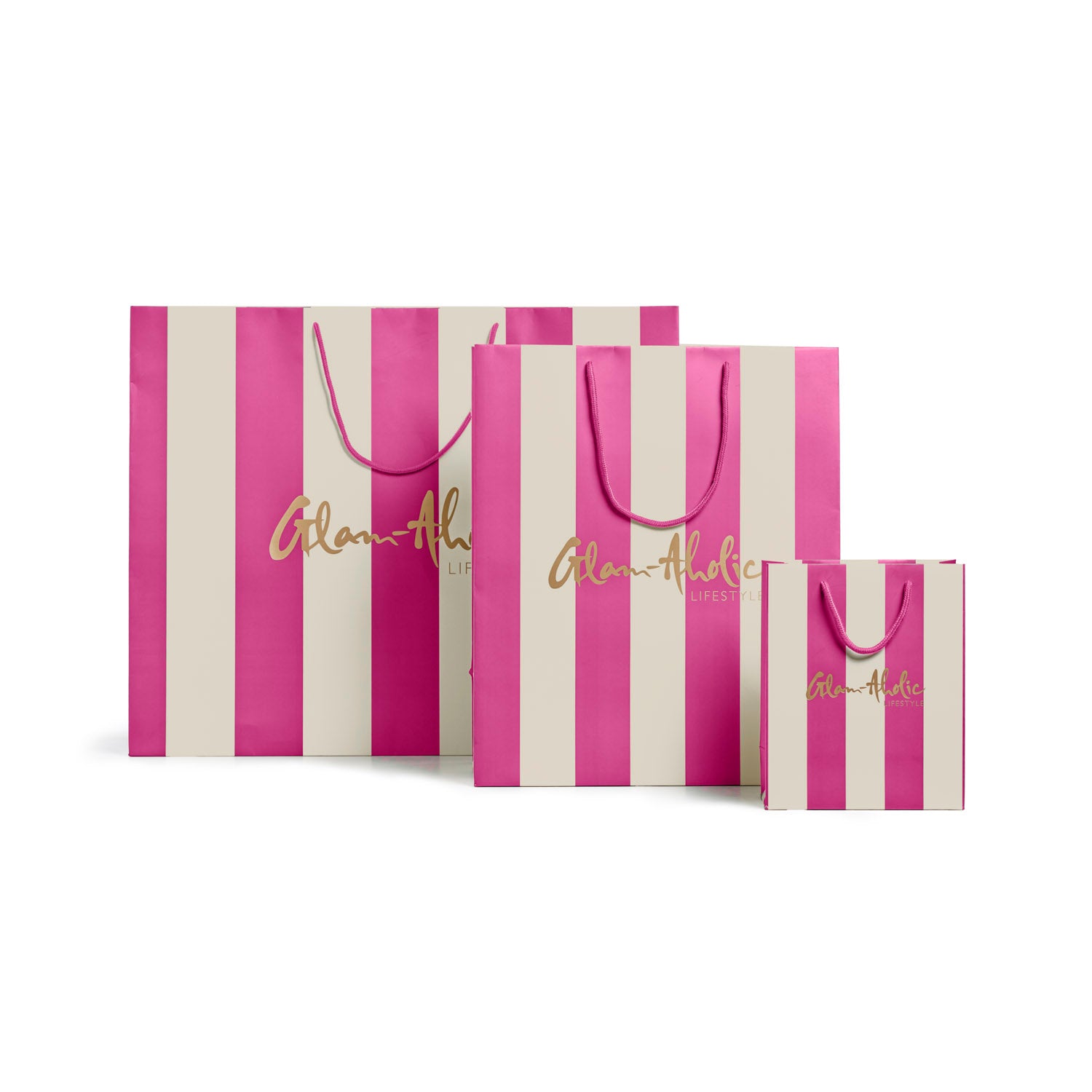 Pink and cream striped gift bags in various sizes featuring Glam-Aholic Lifestyle branding. Perfect for stylish gifting.
