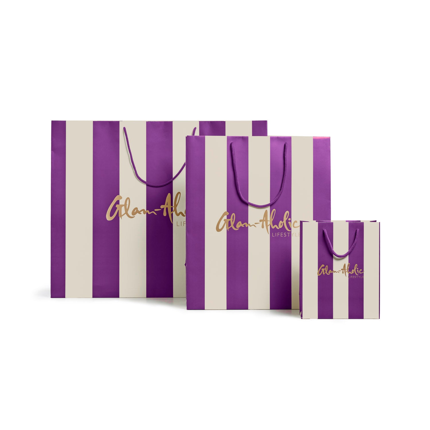 Purple and cream striped gift bags in various sizes featuring the Glam-Aholic Lifestyle logo. Perfect for stylish gifting.